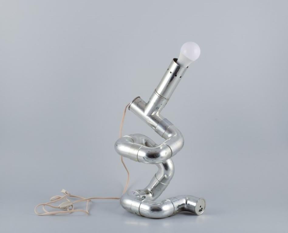 Gaetano Missaglia, Italian designer.
Rombo table lamp composed of pipes in chrome-plated ABS plastic. 
Futuristic style.
1970s.
In good condition with normal signs of use.
Original cord and switch. Cord approximately 100 cm.
Dimensions: H 45.0 cm