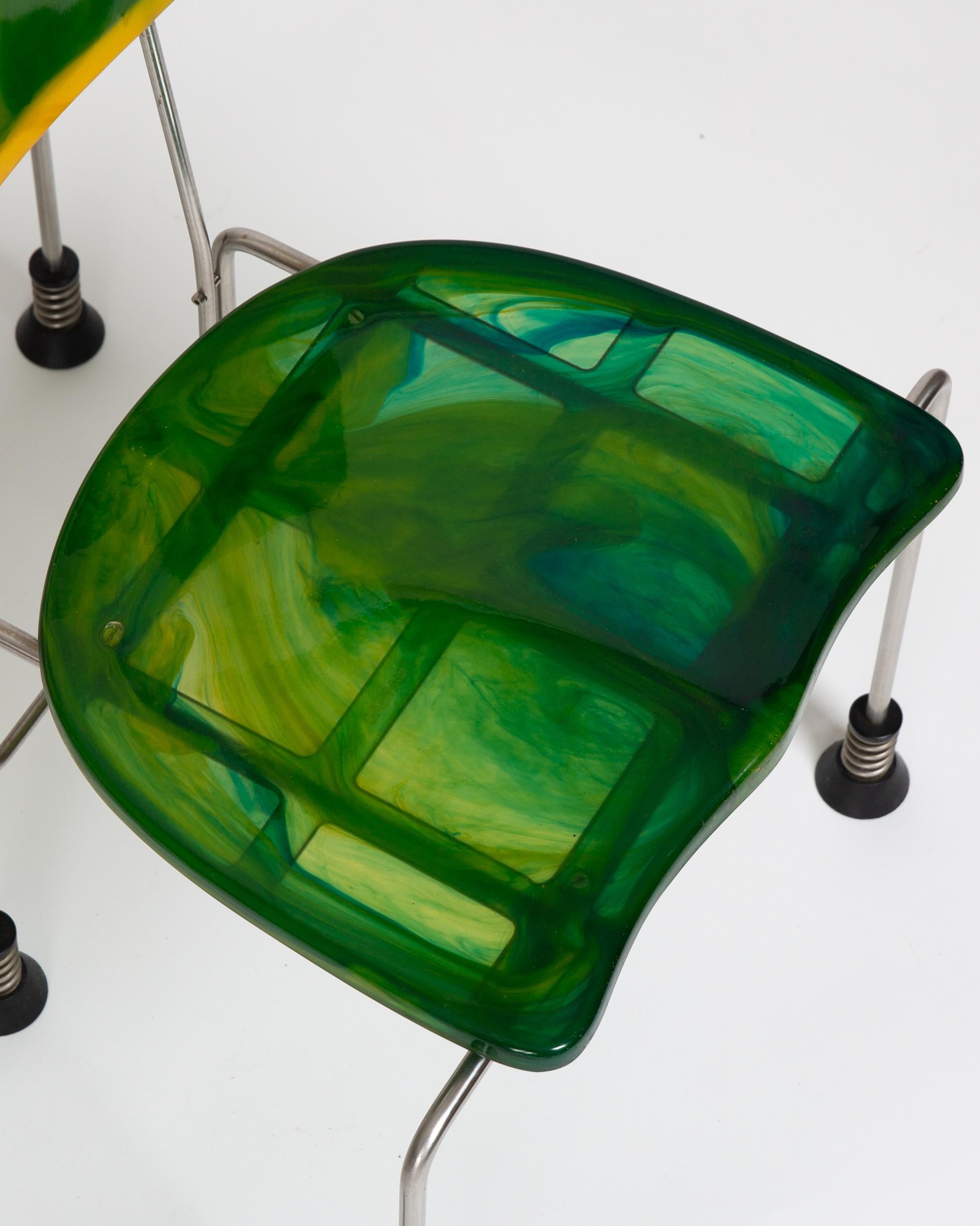 A set of 4 extremely uncommon Broadway Chairs produced by Bernini. 
Each chair is unique and both seat and back are casted in a green/yellow resin. 
A frozen fluidity - portrait of art, science and time or perhaps resembling some swirled out smokey
