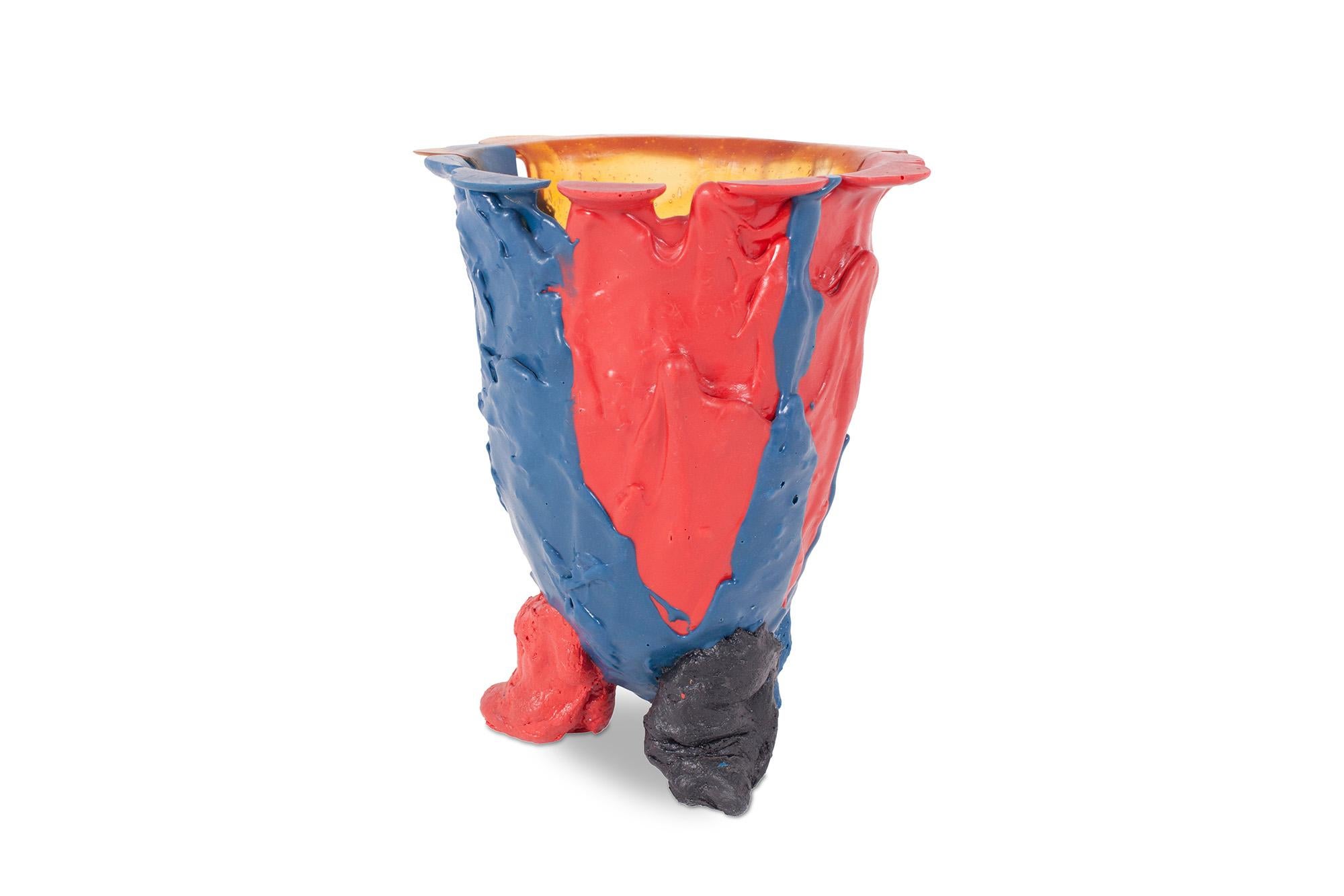 Multi-colored resin vase designed by architect & designer Gaetano Pesce. The vessel stands on three small legs. The body is created by different casted layers of resin, all in different colors, resulting in a very bright and playful aesthetic