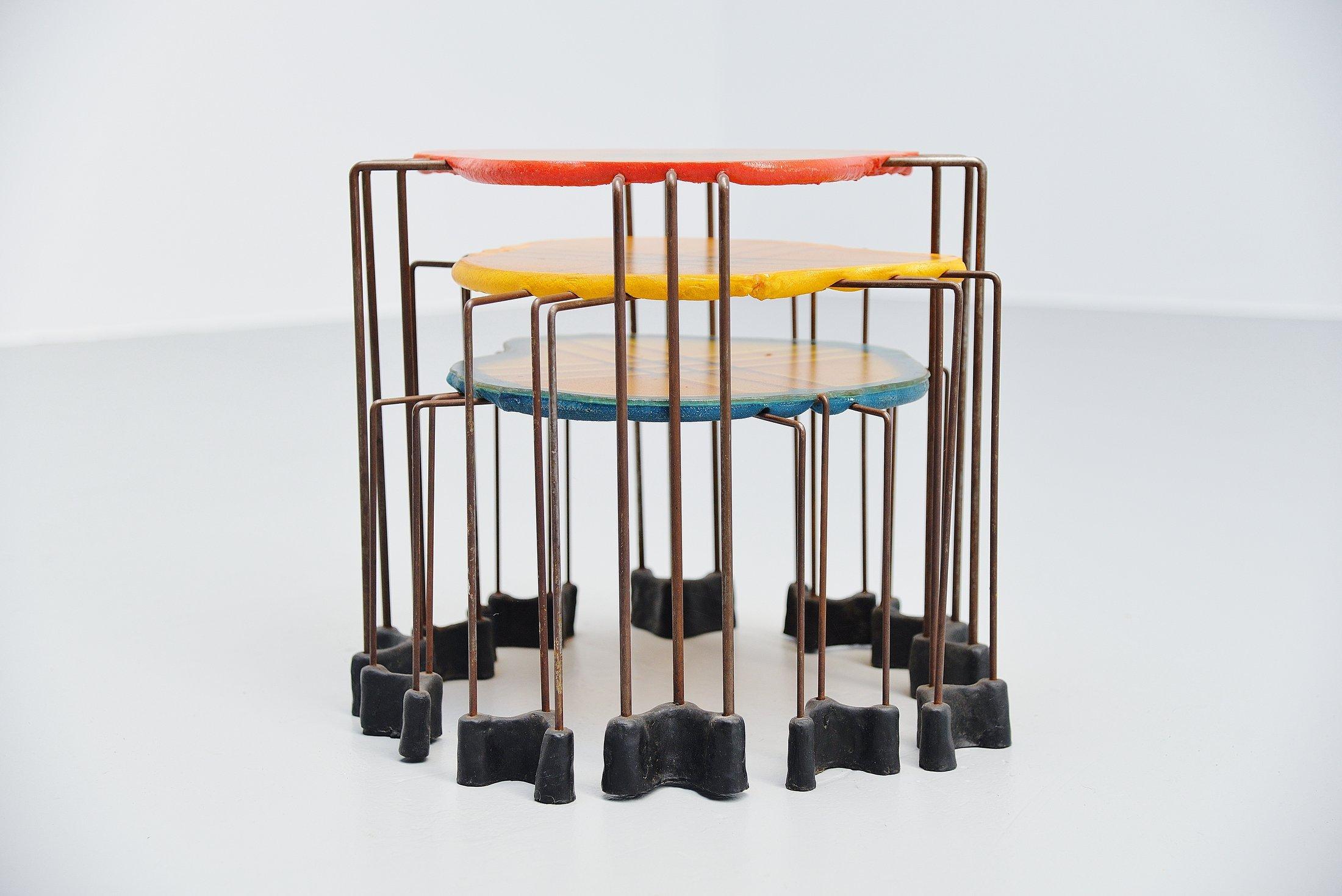 Very nice and early set of unique nesting tables designed by Gaetano Pesce and manufactured by Fish Design, Italy, circa 1990. These early tables are made of resin tops and feet and have metal structures. The tables have a nice patina from age, the