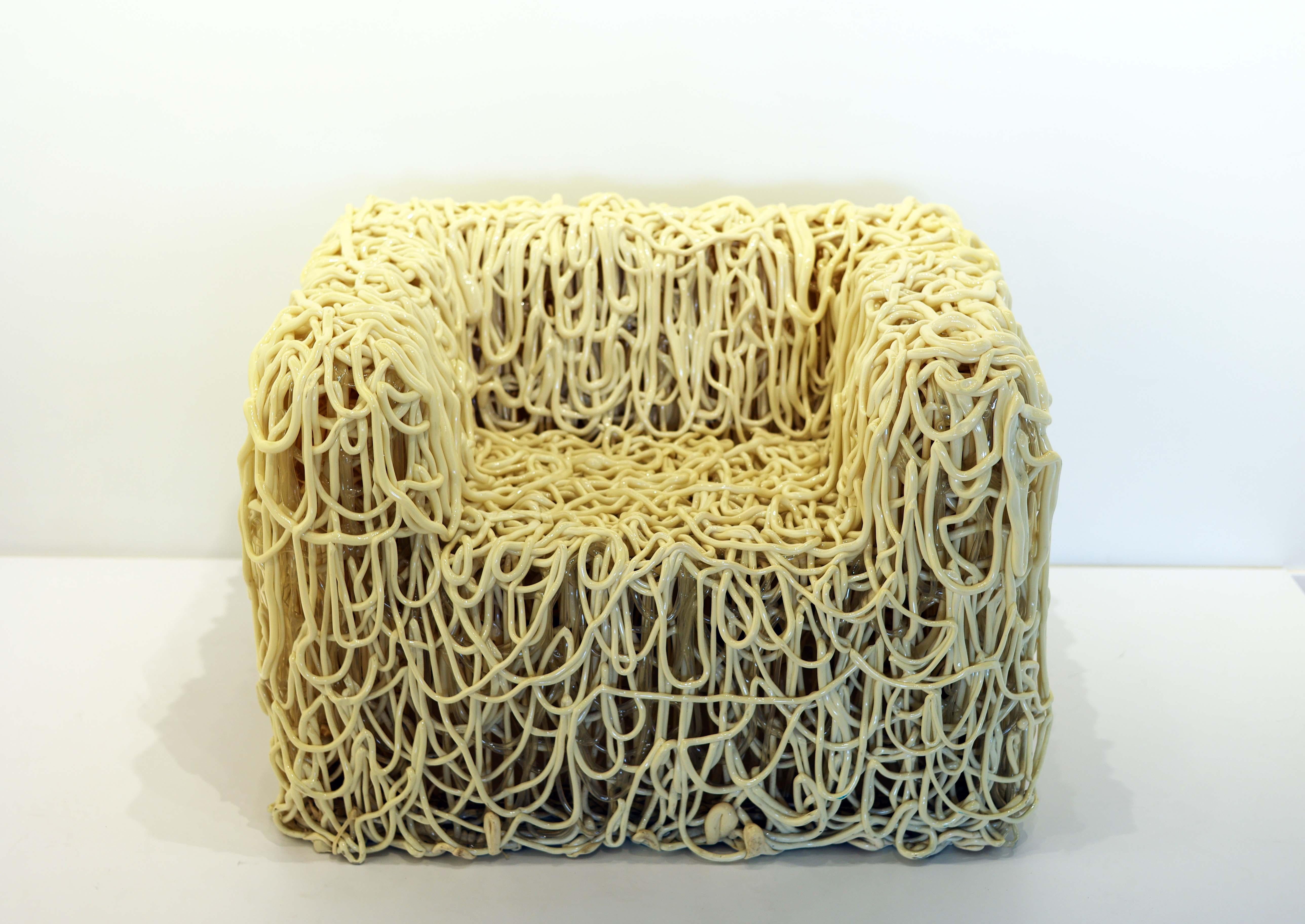 A cord of extruded polyurethane molded into the shape of a chair. Each chair is a unique work of art. This is a very heavy example with both clear and off white cords. One of very few if not the only example with two colors of polyurethane. In