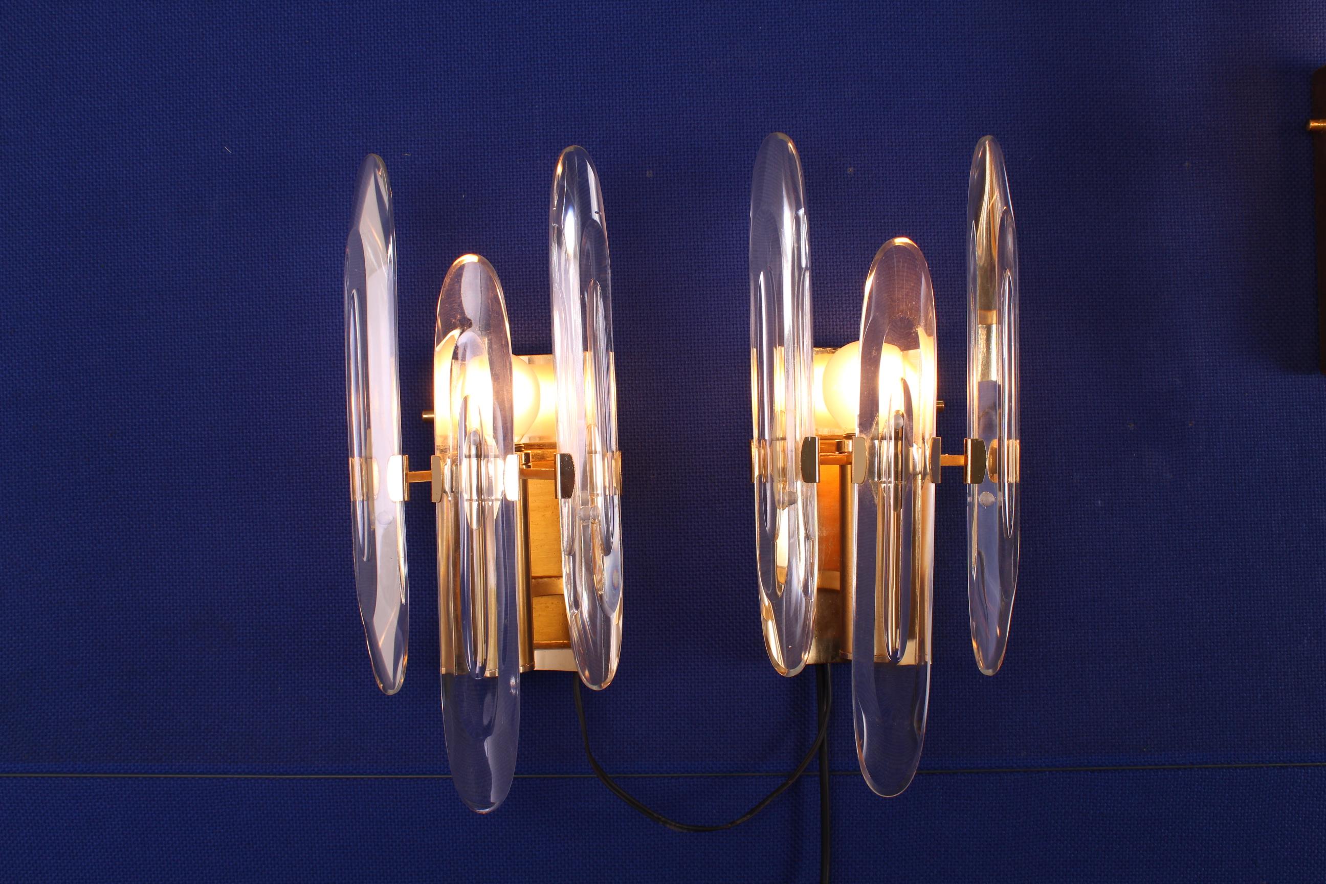 Set of 4 wall sconces designed by Gaetano Sciolari, in brass and glass.Italy  1970,
Wear consistent with age and use.