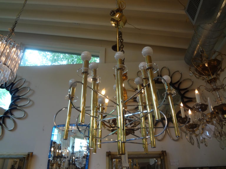 Stunning Italian brass and chrome 12-light chandelier signed Sciolari. This gorgeous Mid-Century Modern Italian chandelier can be modified to needed height or hung by chain. Our Italian Hollywood Regency chandelier in very good vintage condition