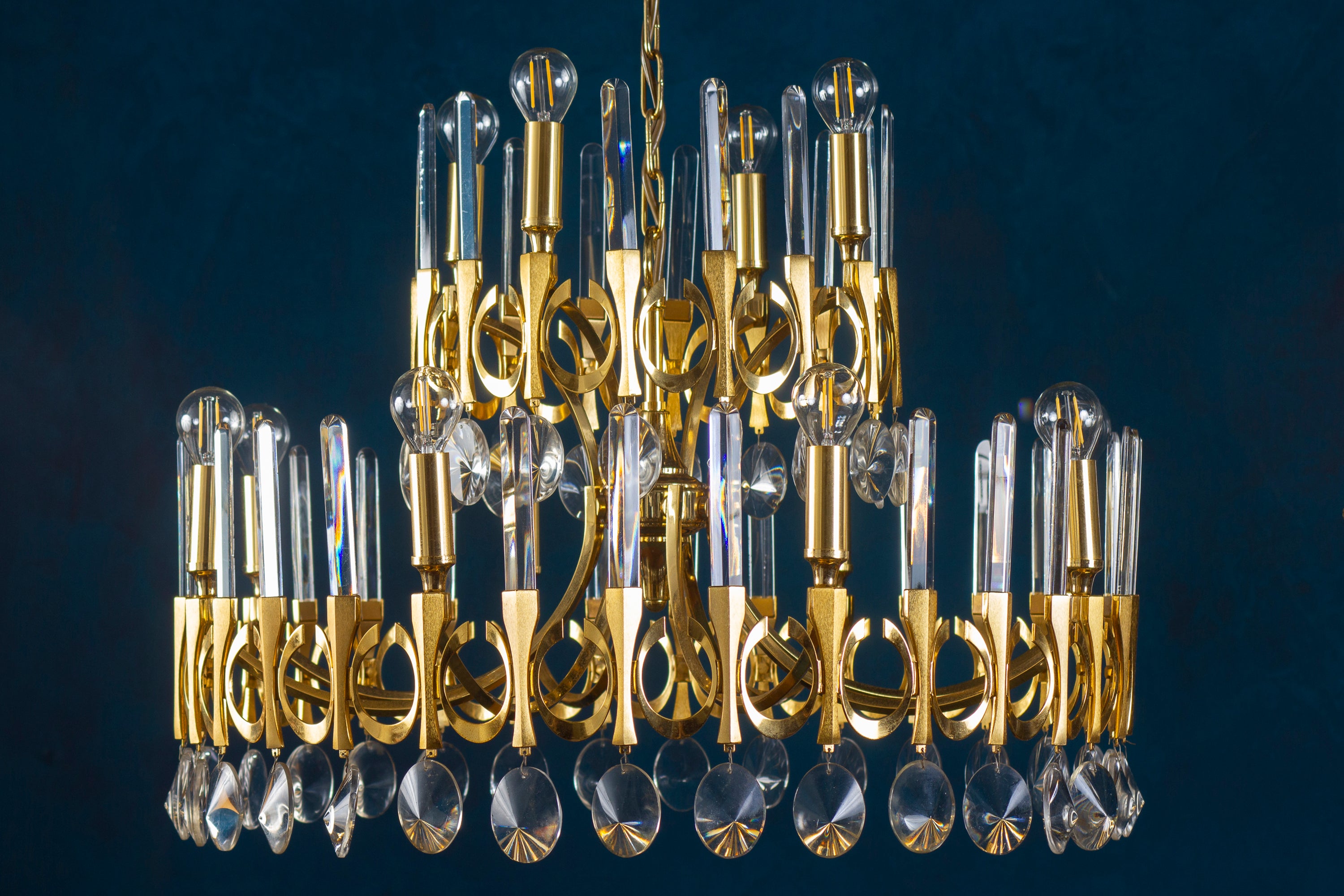 Italian, large midcentury Gaetano Sciolari two-tier chandelier featuring in the original brass finish with fine Murano glass drops Top tier holds six sockets, bottom tier also six sockets for a total of 12 candelabra based sockets. Can use either