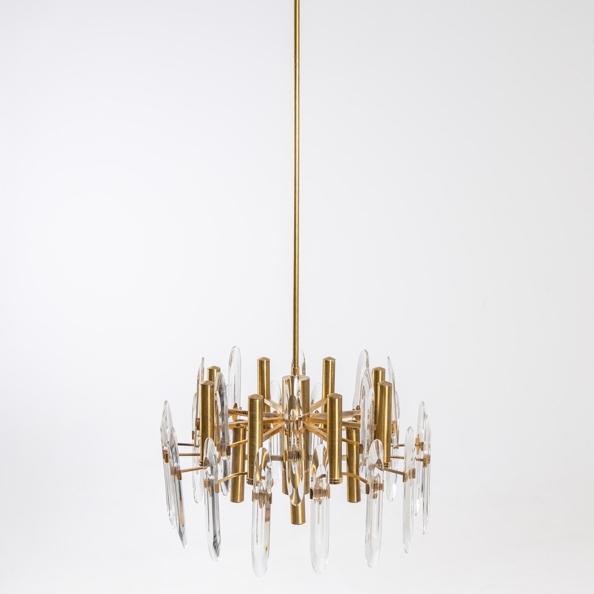 Large brass chandelier with eight sockets and oval glass elements by Gaetano Sciolari.