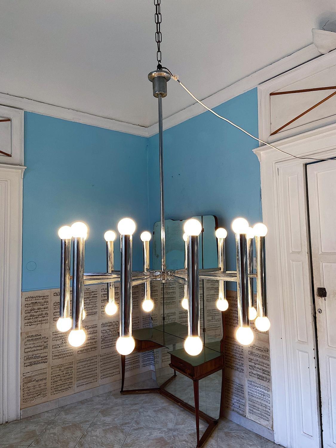 A Gaetano Sciolari brushed stainless steel twenty-arm light fixture with sockets at each end of the extended tube arm. Beautiful, even more so in real life. 24 light bulbs.