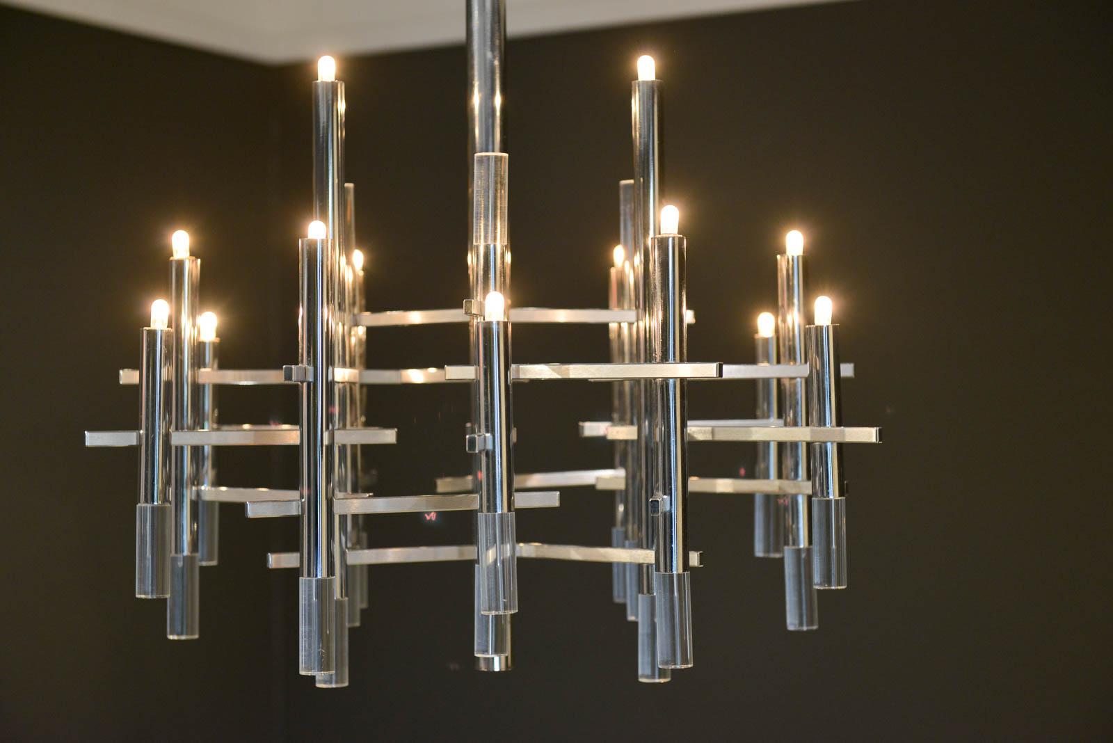 Gaetano Sciolari chrome and Lucite chandelier, circa 1970. Sculptural modern chandelier designed by Gaetano Sciolari in Italy, circa 1970s. This elegant chandelier features twelve chrome and Lucite vertical cylinders, nine of which hold the