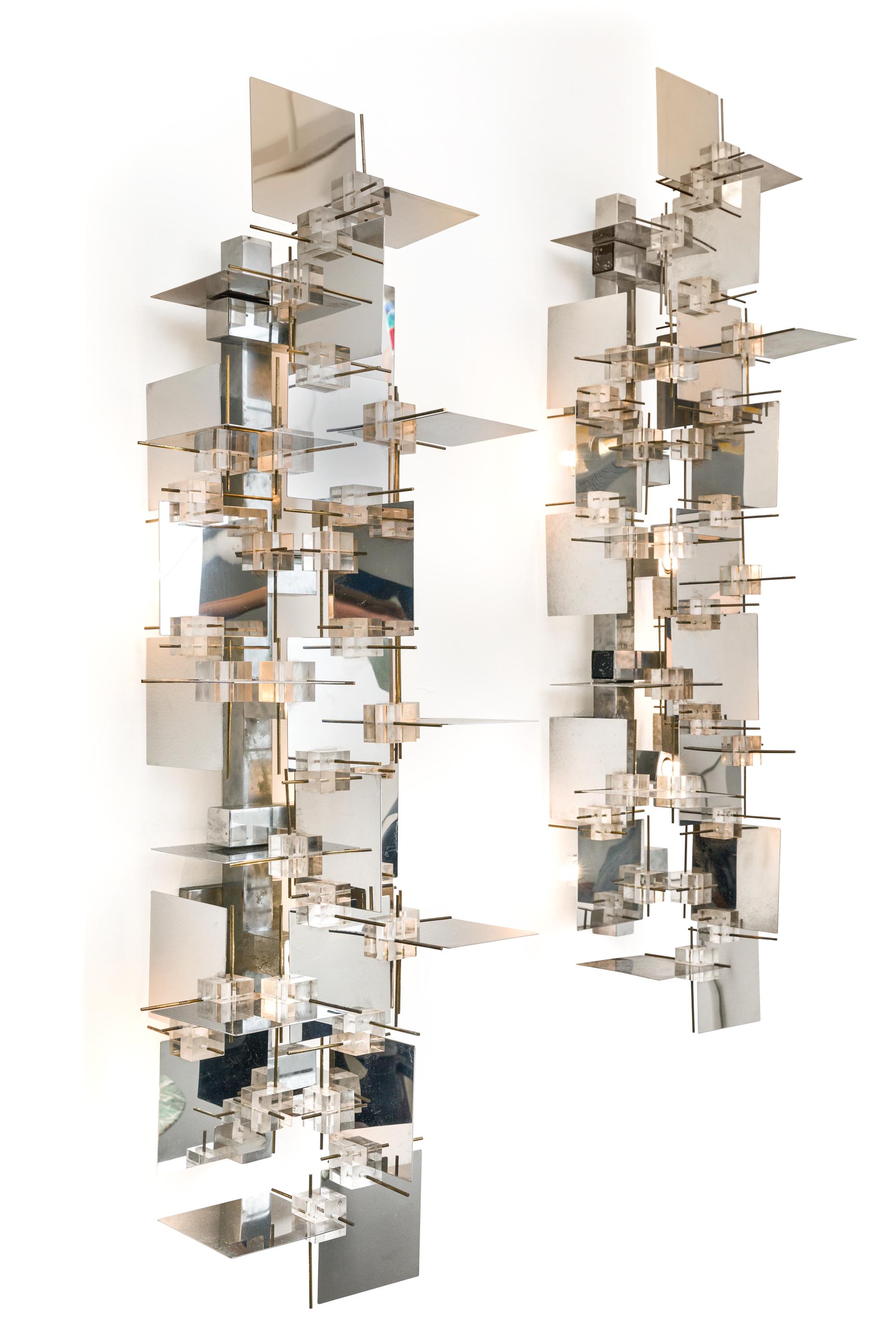 A rare and impressive pair of sconces by Gaetano Sciolari. The chrome panels create a wonderful effect reflecting the light at every angle. There is some discoloration to the Lucite cubes that is only apparent when observed closely.