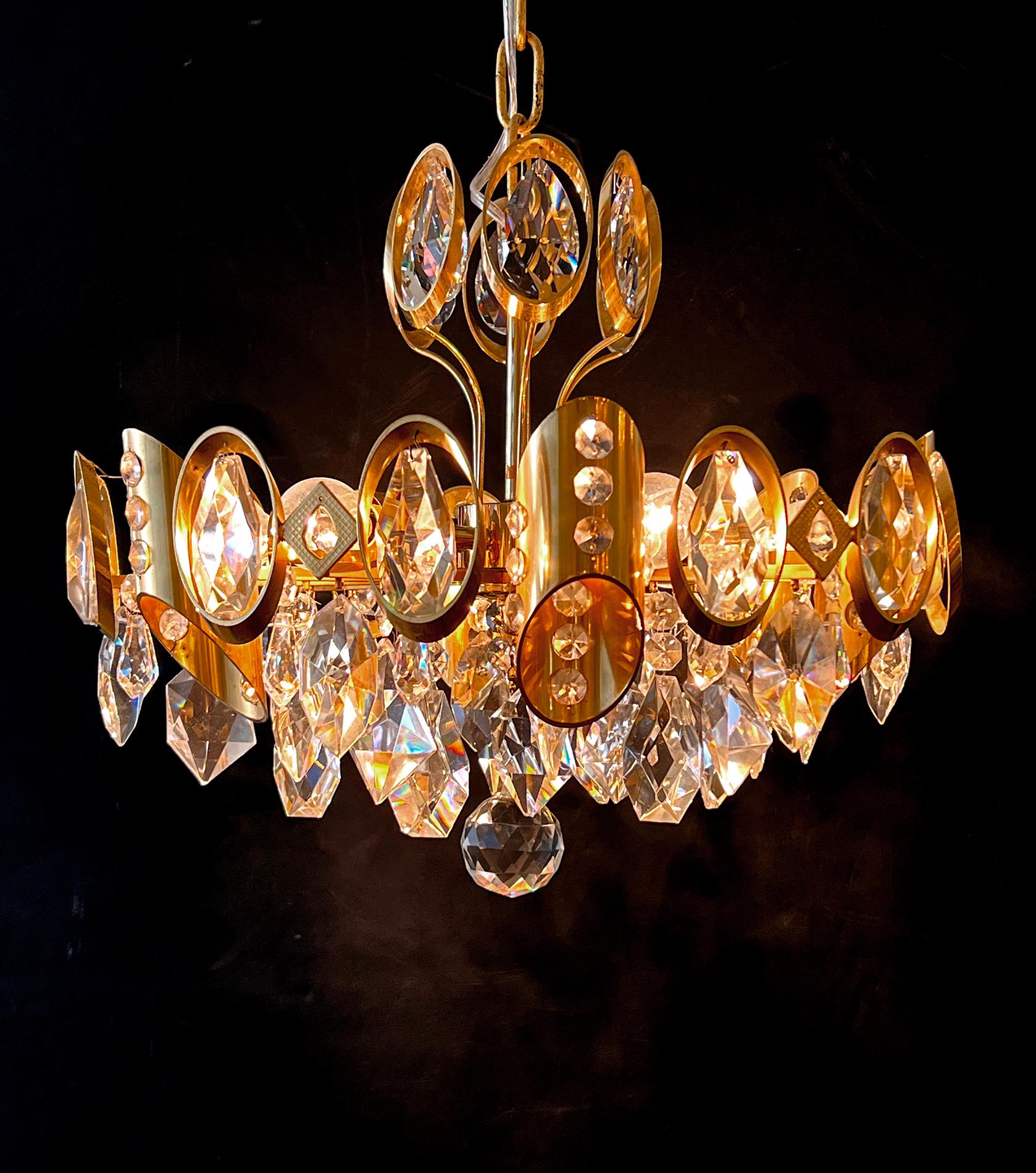 this stylish Hollywood Regency gilt-brass and crystal pendant light fitted with over-scaled round faceted crystal elements; great statement piece for a powder room, small hallway or dressing room