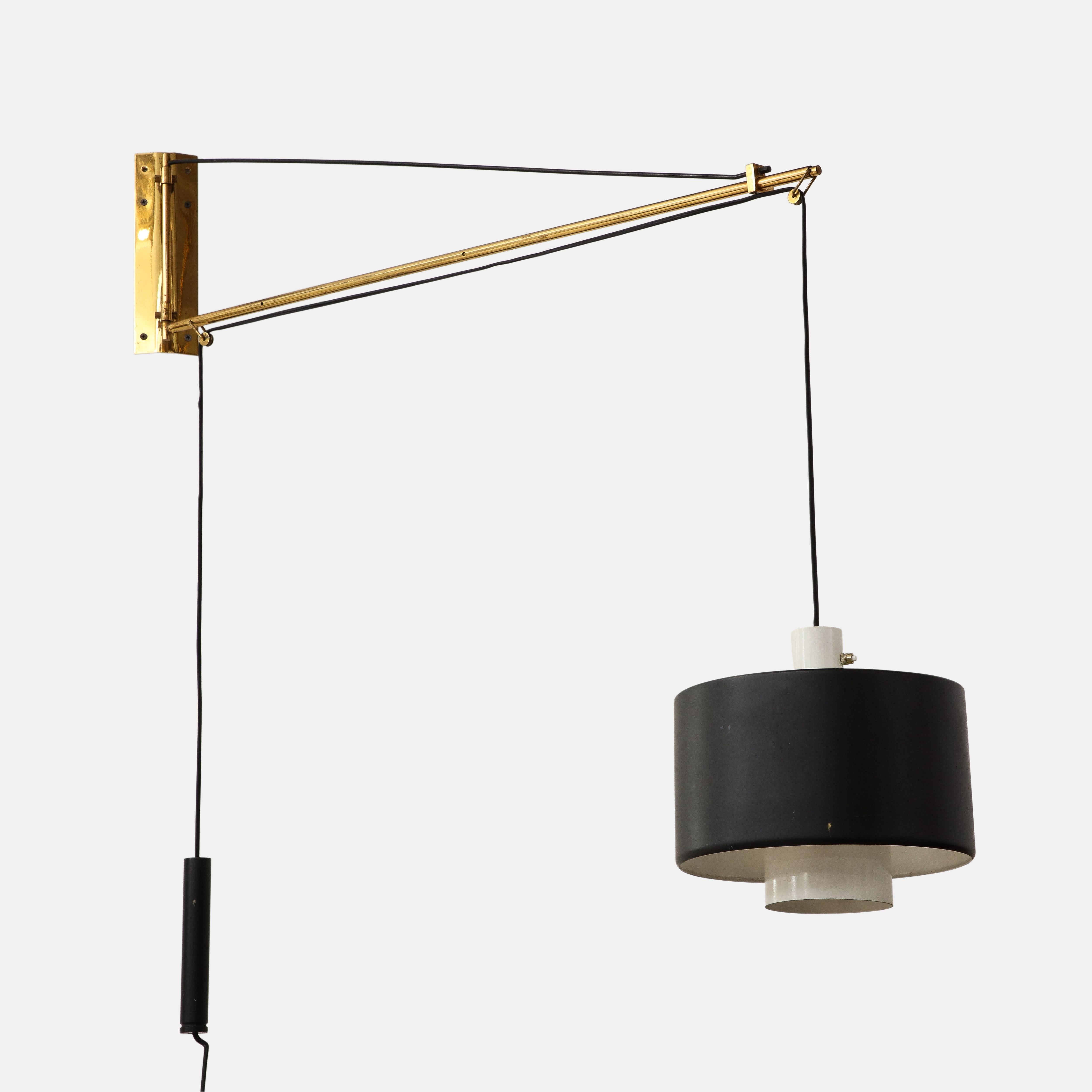 Stilnovo wall light model 2061, Italy, circa 1957. Wall-mounted counterbalance swing arm lamp with brass arm, black enameled metal shade, and counterbalance pulley mechanism for raising and lowering the shade. Signed on backplate 'stilnovo
