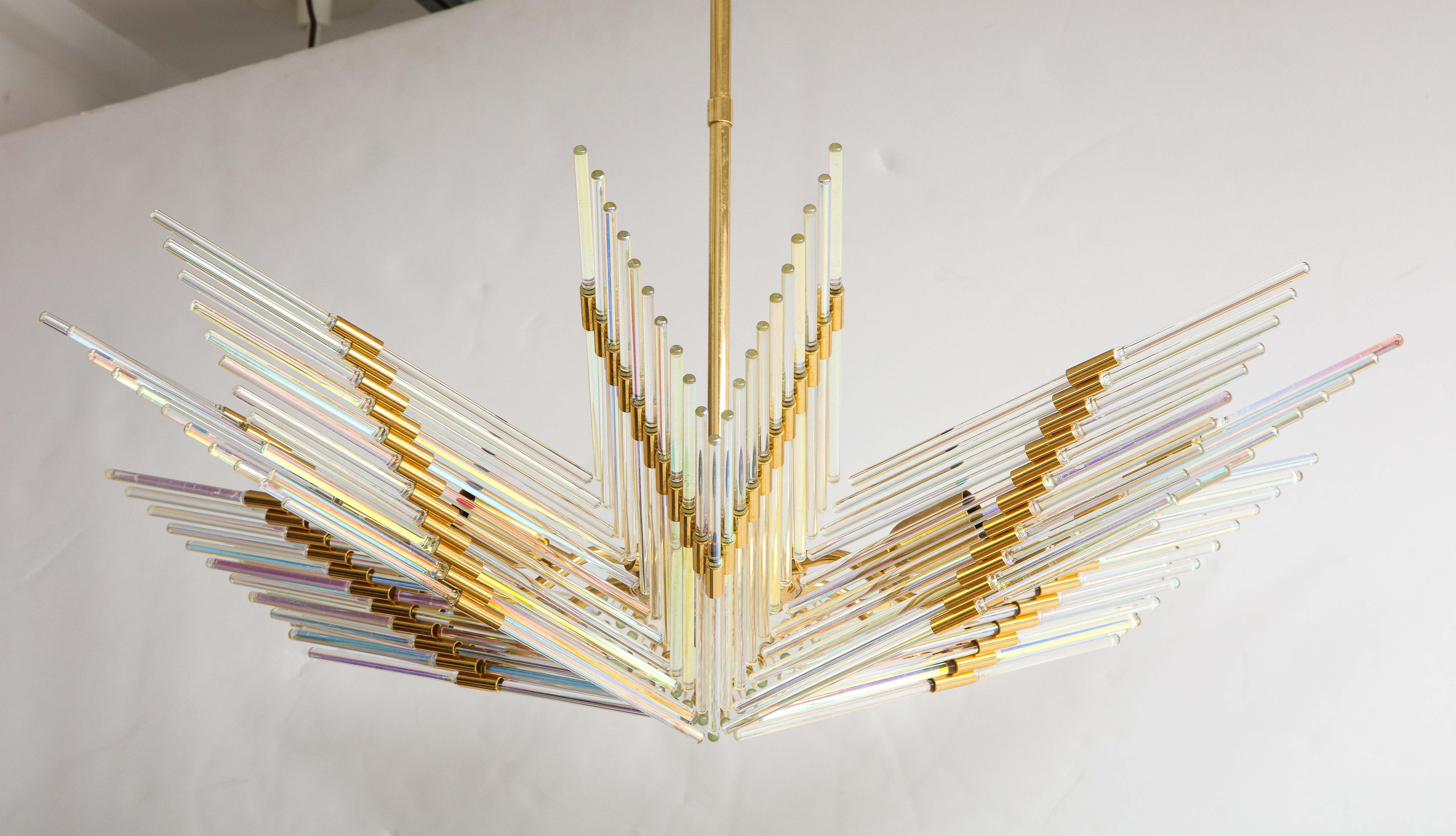 A Gaetano Sciolari iridescent and gold plated chandelier. The 'wings' of the chandelier emanate from a central gold plated stem, with iridescent glass rods inserted into individual gold plated rings. A very unique piece, which would make for a