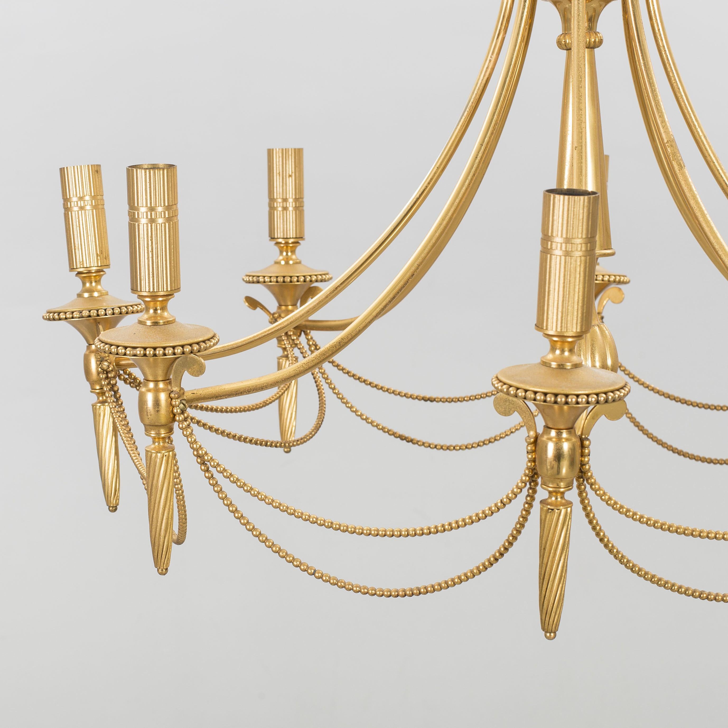 Beautiful patina. Italian brass chandelier by Gaetano Sciolari, from the early second half of the 20th century. Unusual and elegant. Great for transitional spaces.