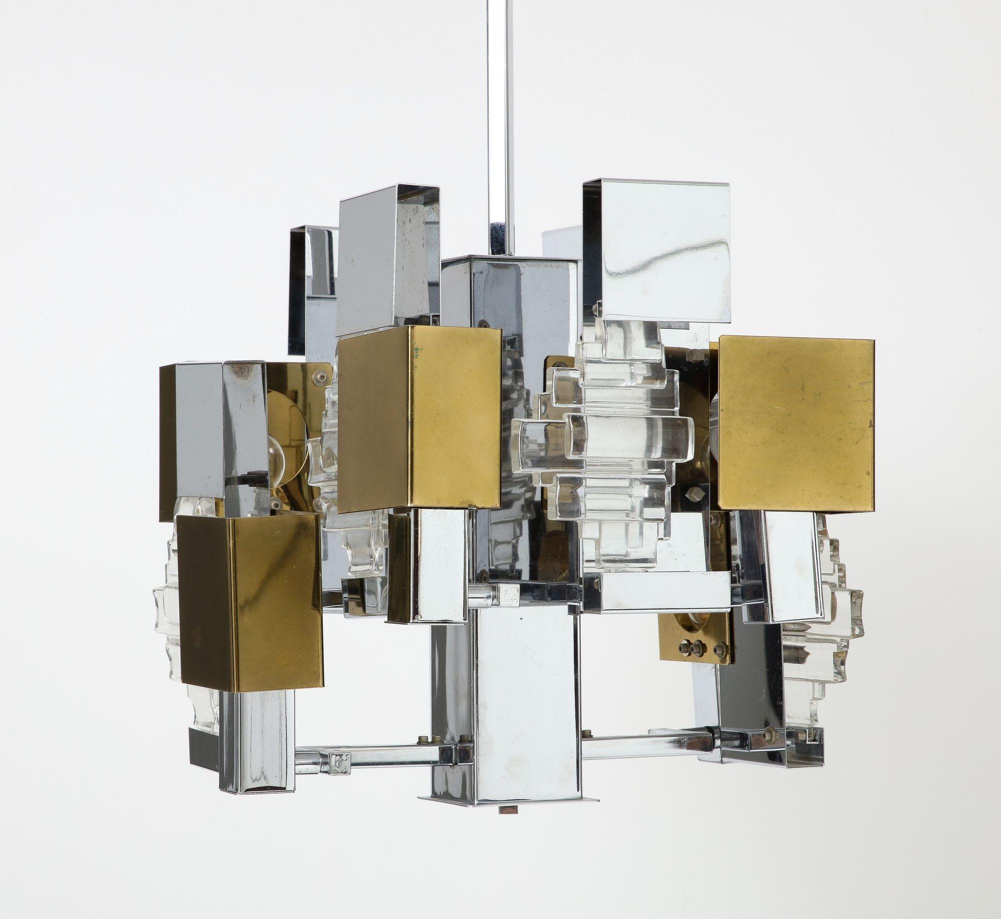 Gaetano Sciolari Italian Modern Cubist chandelier in chrome, brass, and glass elements, circa 1960s.  A geometric composition that is reminiscent of glass and steel skyscrapers. Measures: 35