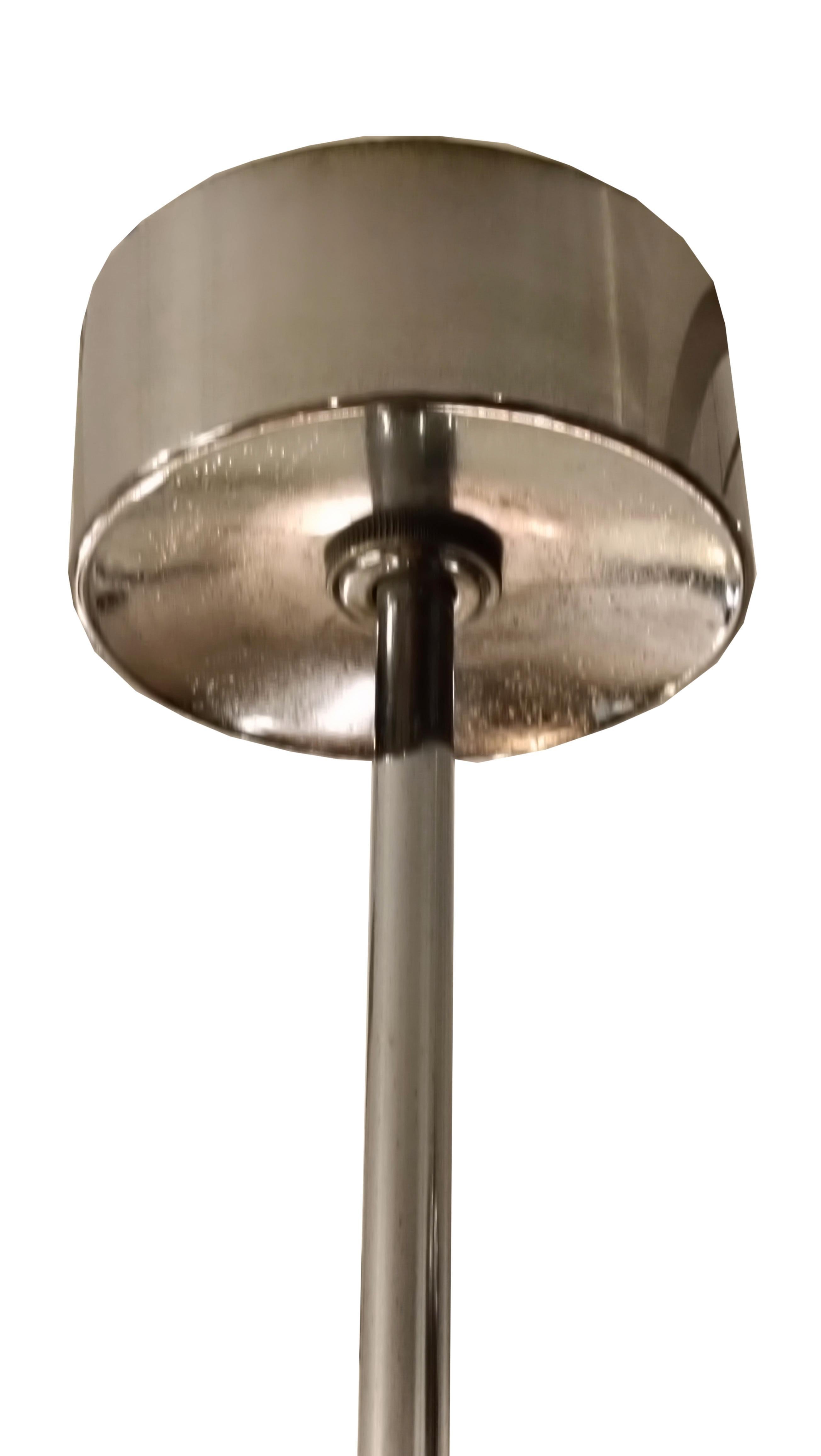 Space Age chandelier, designed by Gaetano Sciolari and made in Italy around the 1970s, exemplifies timeless elegance. Constructed from brass and nickel, it features clean lines creating an architectural piece. The clear glass discs reflect light for