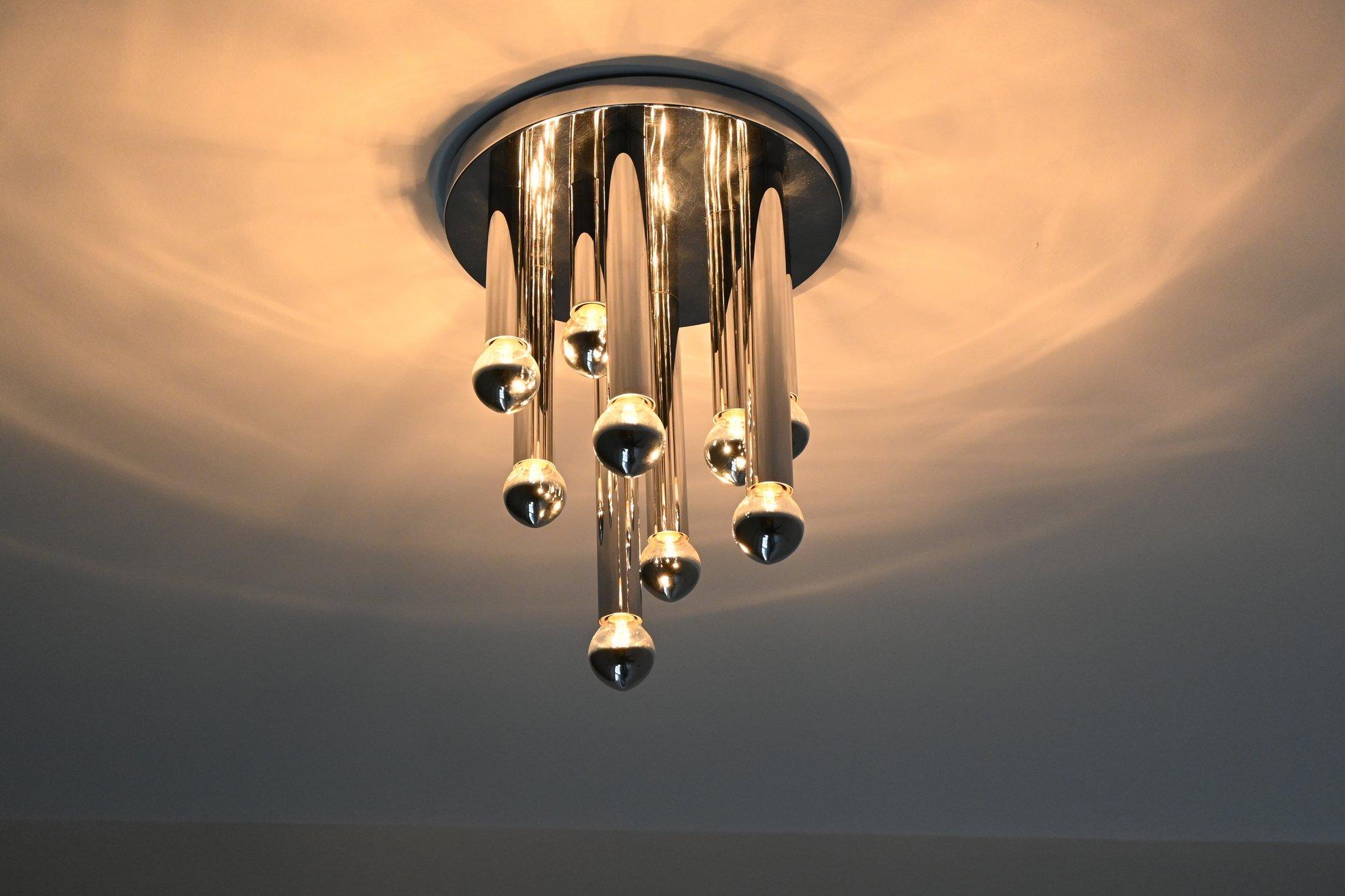 Very nice atmospheric Flush mount ceiling lamp designed by Gaetano Sciolari for Boulanger, Italy, 1960. This Regency style large ceiling lamp has 9 chromed metal tubes with different lengths hanging on a chromed metal plate. It brings a marvelous