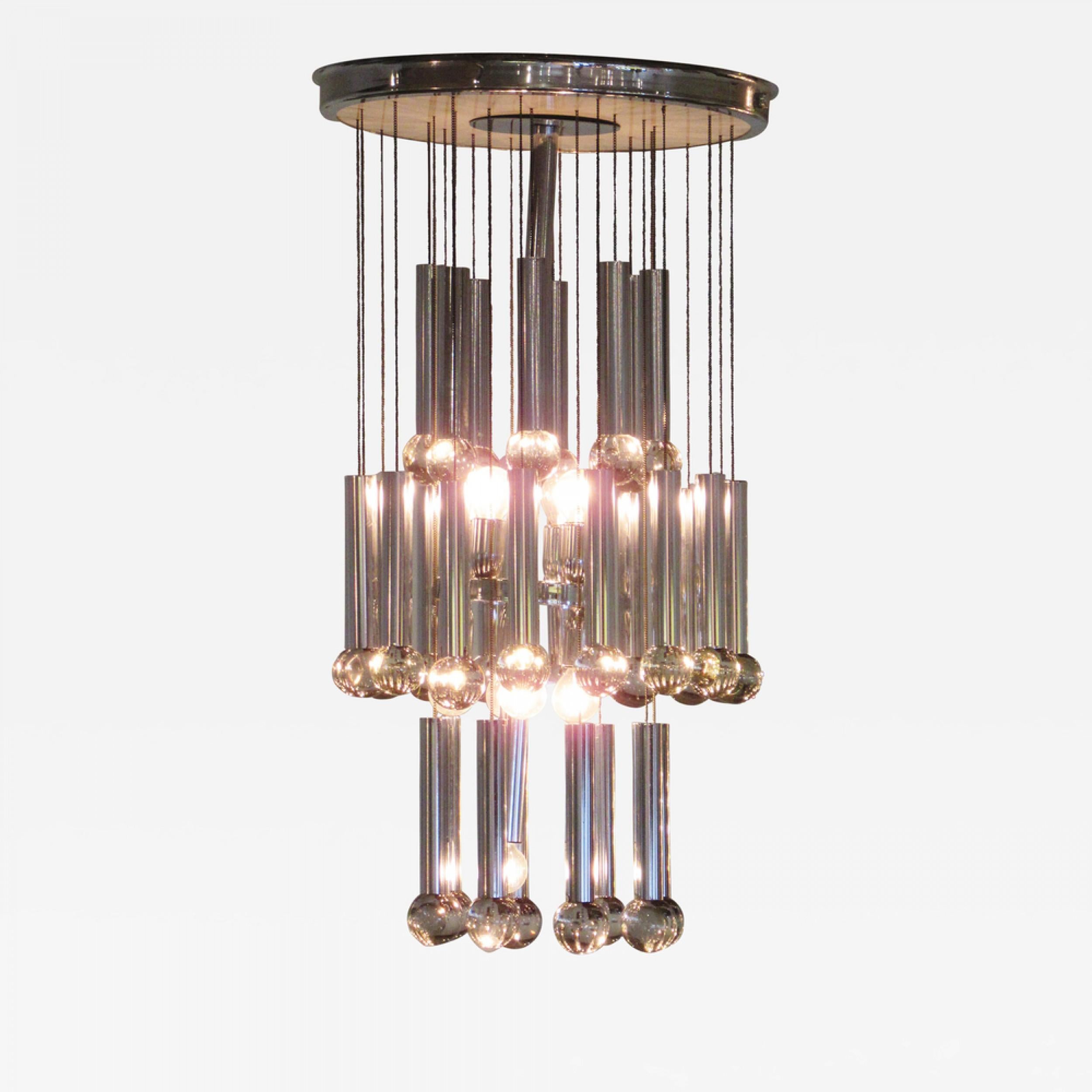 Italian Midcentury (1960s) chandelier comprised of three tiers of hanging polished chrome cylindrical lights. (GAETANO SCIOLARI).