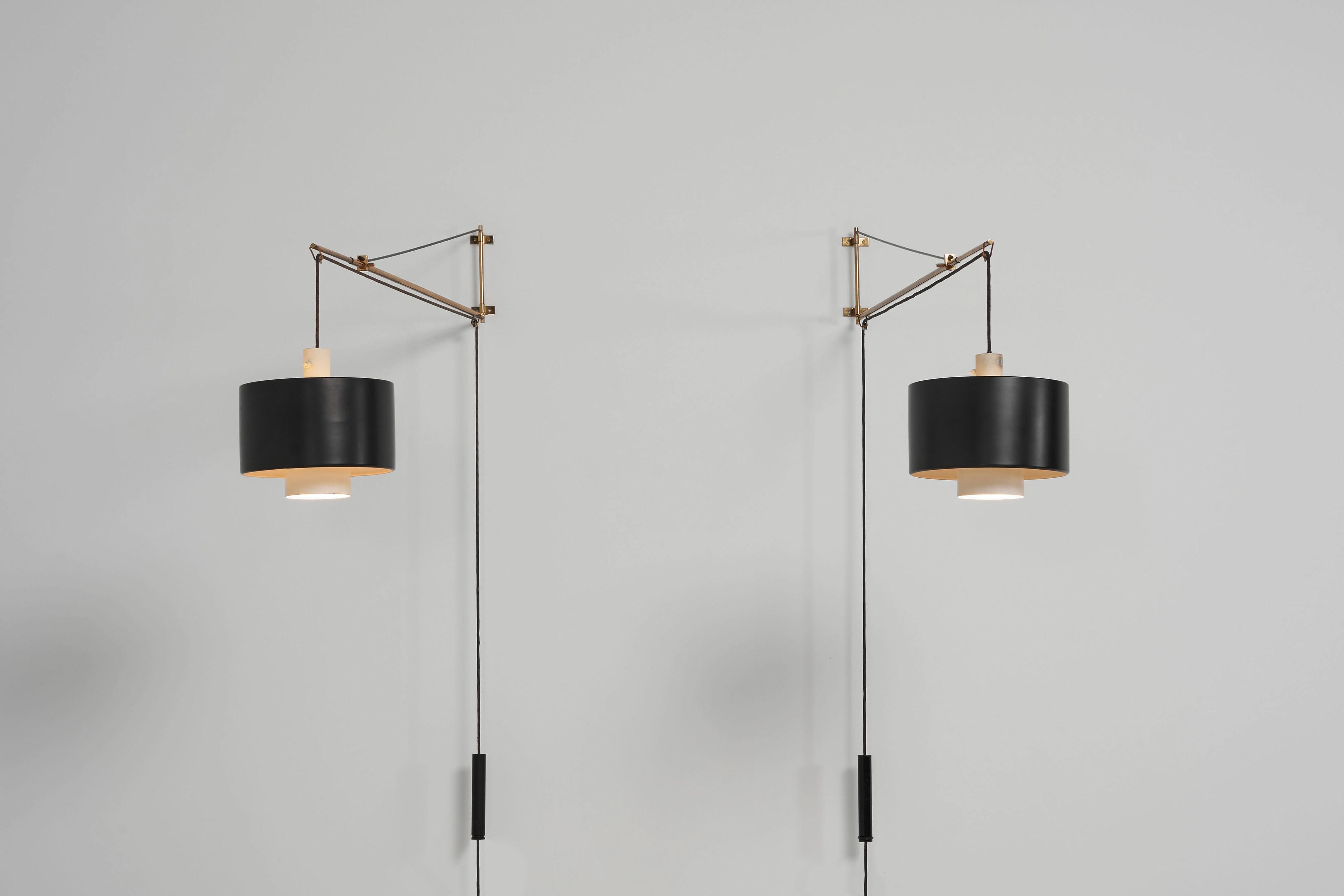 Exceptional Model 2061 wall lamps designed by Gaetano Sciolari and produced by Stilnovo in Italy in 1954. These are the rare first productions made from brass, featuring a different wall plate. They're in fully original condition and still bear the