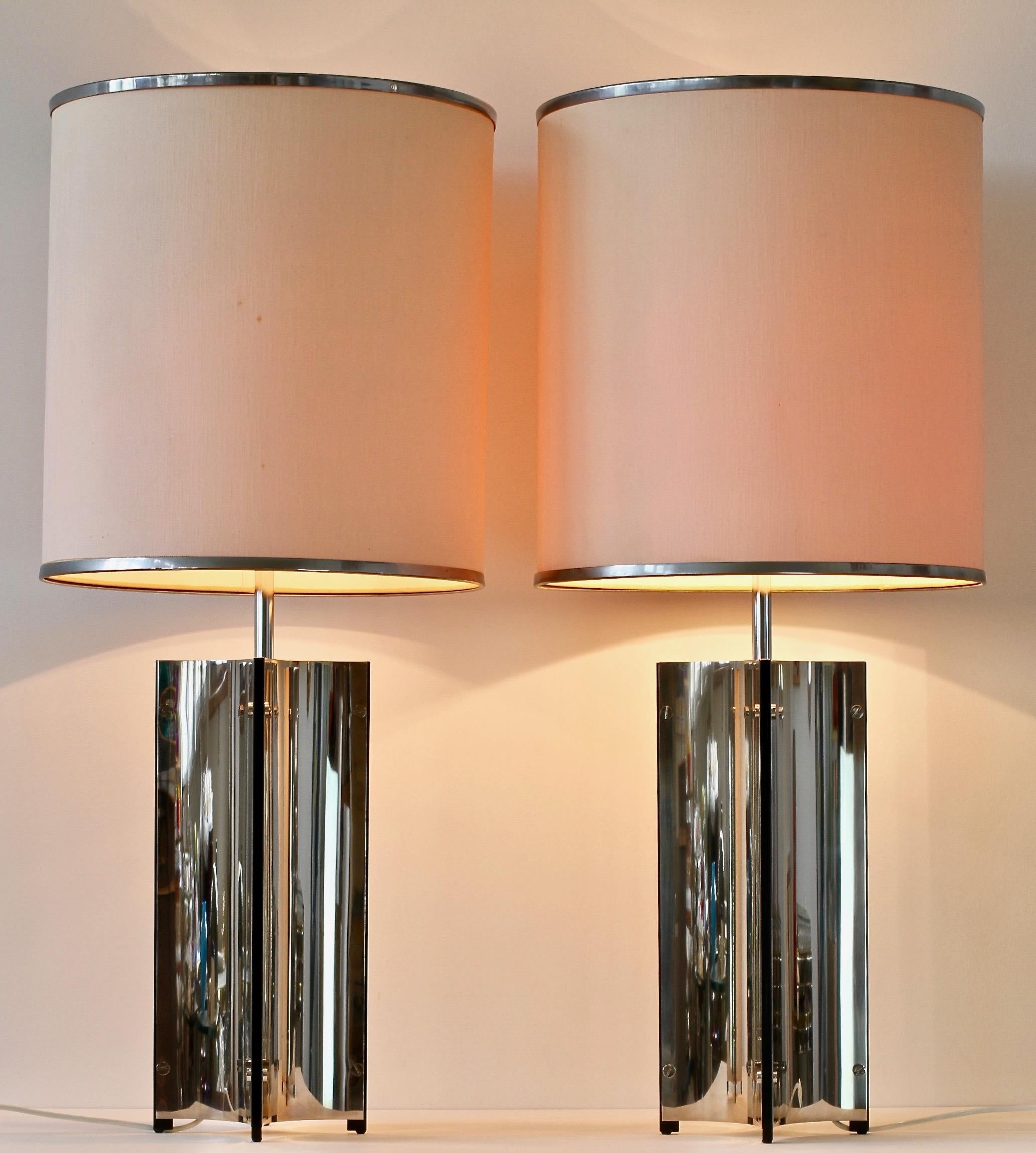 Monumental tall Mid-Century Modern vintage pair of Italian oversized, large-scale table or floor lamps by Gaetano Sciolari circa 1970s. Featuring polished curved bent sheets of steel, these lamps lend themselves to any modern home decor as well as