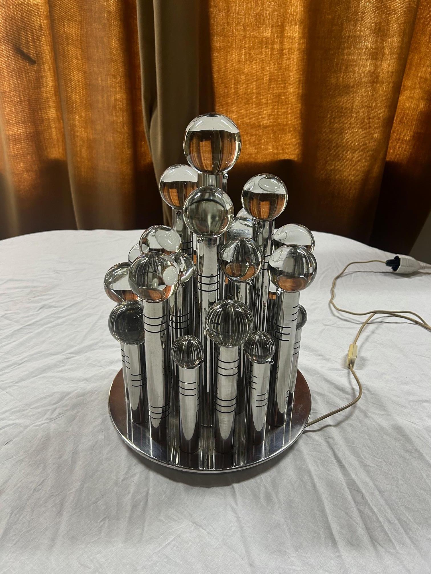 Gaetano Sciolari table lamp composed of 30 cylinders and crystal spheres illuminated by incandescent bulbs that create a dreamlike atmosphere. A masterpiece by designer Gaetano Sciolari.

Angelo (known as Gaetano) Sciolari (1927-1994) was one of the