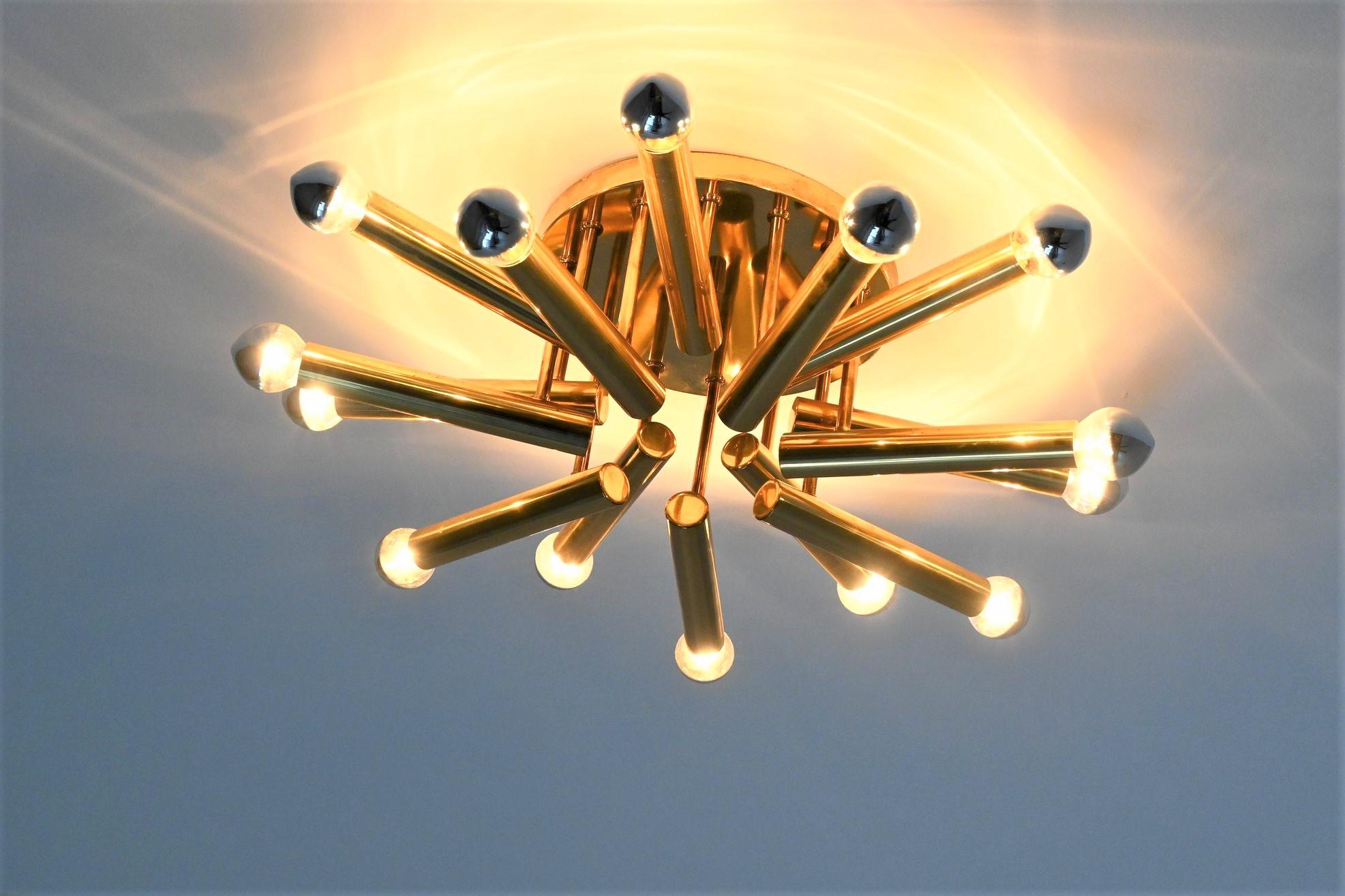 Very nice atmospheric flushmount ceiling lamp designed by Gaetano Sciolari for Boulanger, Italy, 1960. This Regency style small ceiling lamp has 14 brass tubes with different lengths connected with thin tubes to a round brass plate. It brings a