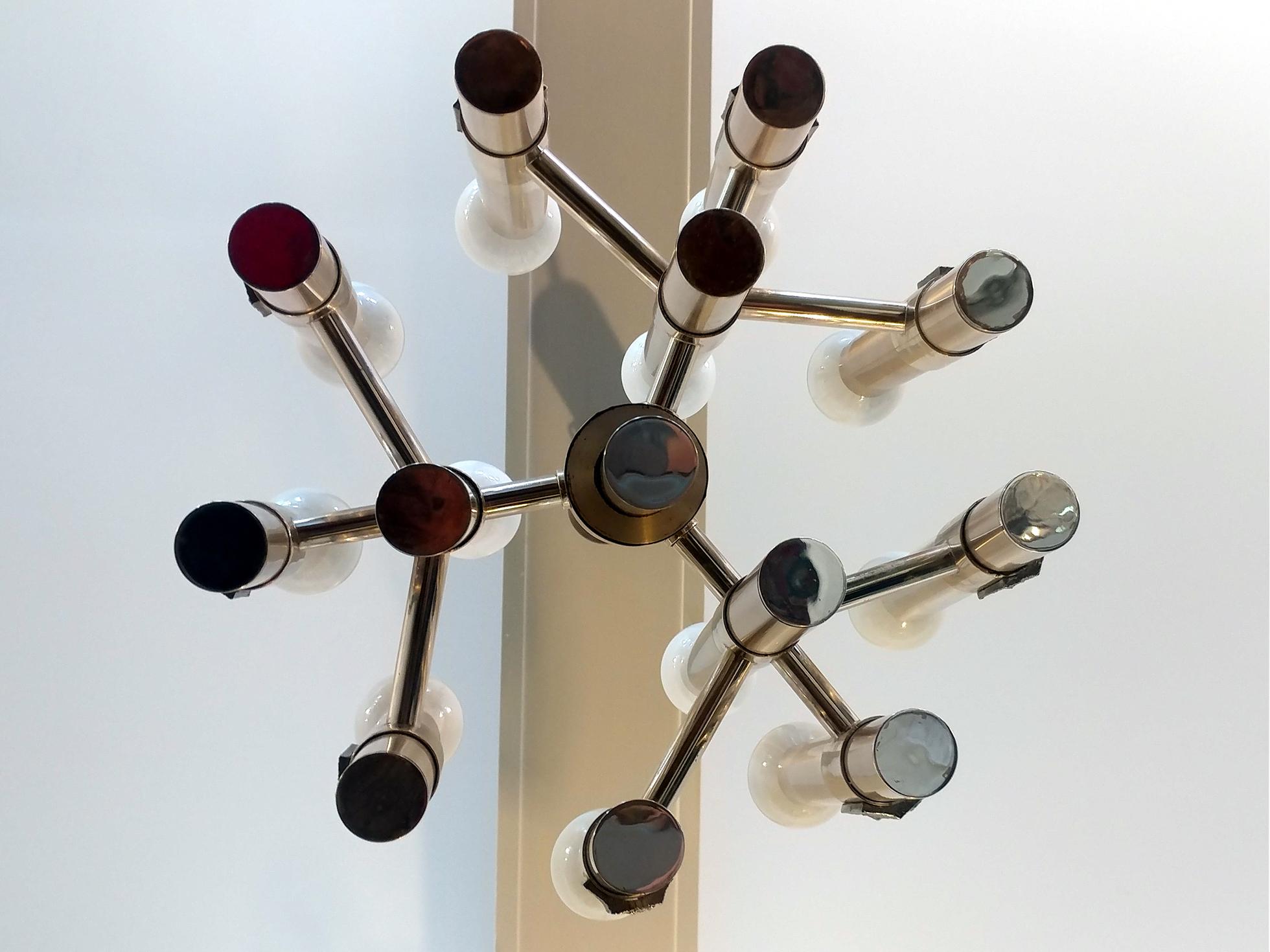 Twelve-light chandelier by Italian modernist Gaetano Sciolari, the fixture has a nice Brutalist detail, similar to the works of Paul Evans or Adrian Pearsall in that same era. All original and in good cosmetic condition appropriate to age and use.