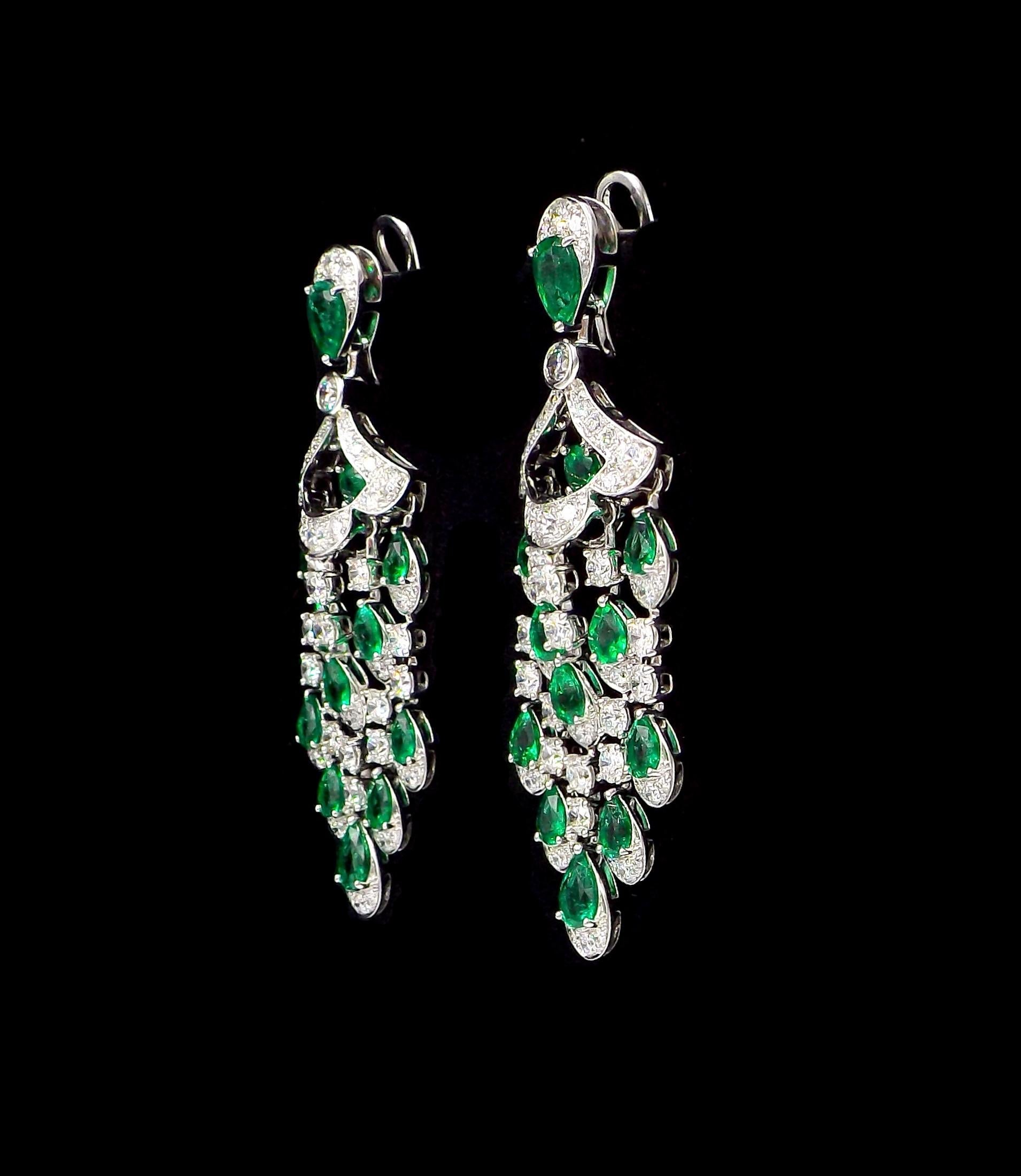 In a design of round and pear-shaped emeralds weighing approximately 6.70cts and accented by round diamonds weighing approximately 5.25cts, mounted in 18k white gold, measures 5/8 x 2 3/8in., signed Graff, numbered.