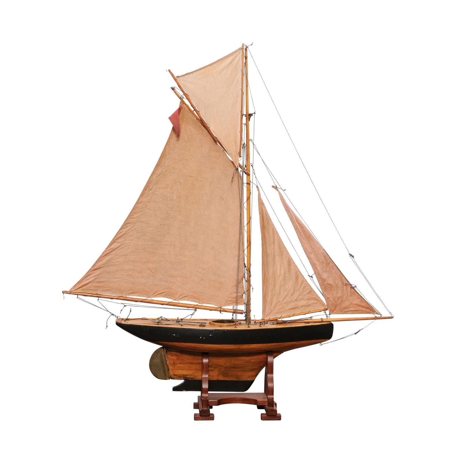 An English Gaff Cutter pond yacht from circa 1920, with solid hull. Step back in time to the George V period with this elegant English Gaff Cutter pond yacht, a remarkable creation from circa 1920 that captures the essence of a bygone era. Crafted