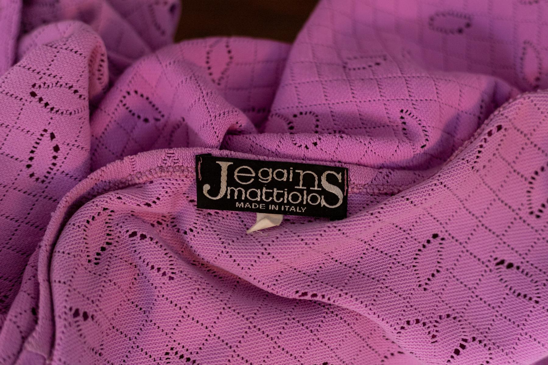 Lovely, colourful light purple buttoned jumper designed by Gai Mattiolo in the 1990s, made in Italy. Original label.
The jumper is made from a light violet cotton, very nice.
The neckline is deep, but not vulgar, it ties with 4 pink buttons that
