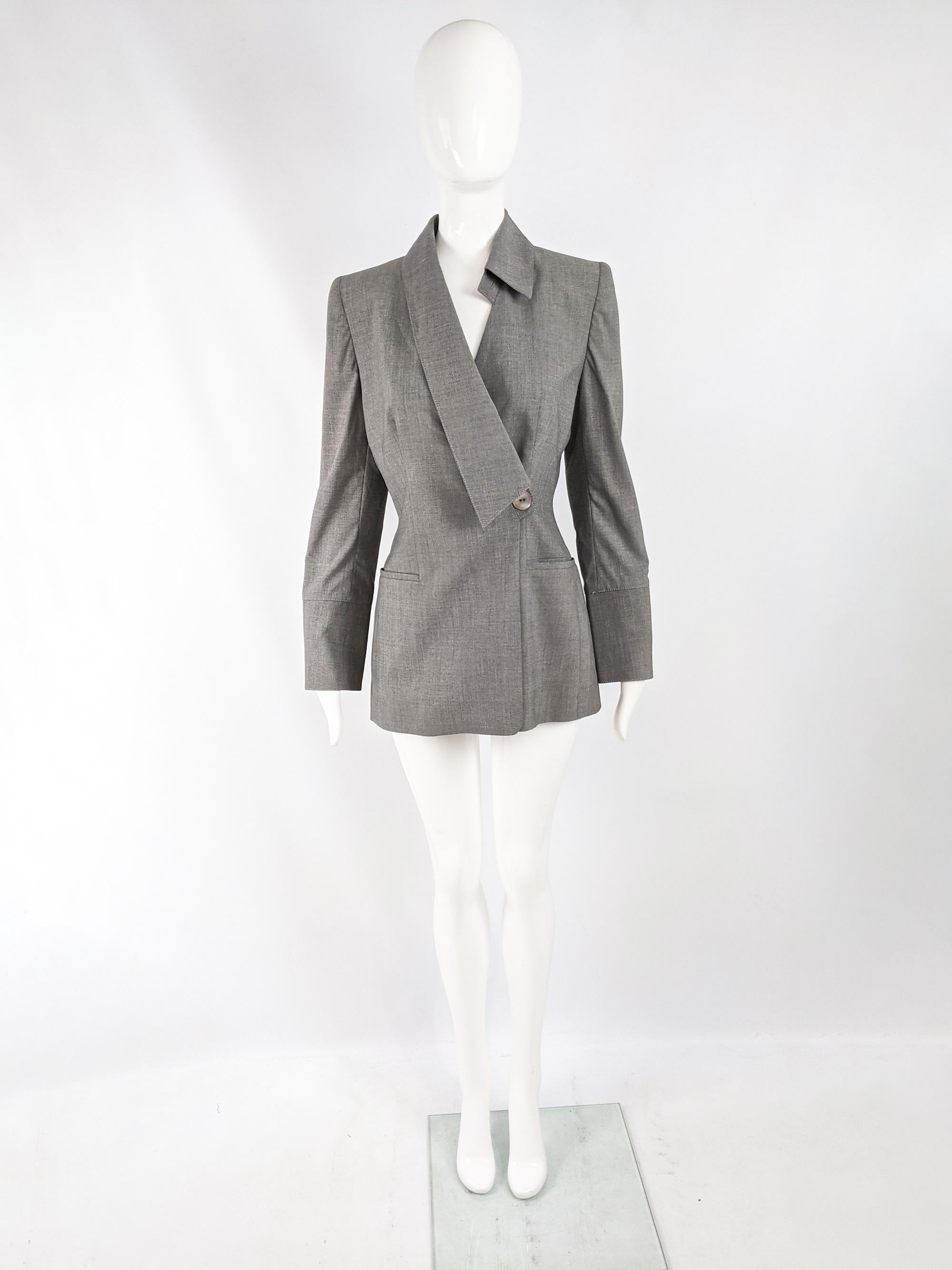 A chic vintage womens blazer from the 90s by luxury Italian fashion designer, Gai Mattiolo. In a grey virgin wool and spandex with an asymmetric collar, mother of pearl buttons on the front and sleeves and small shoulder pads that give an edge to