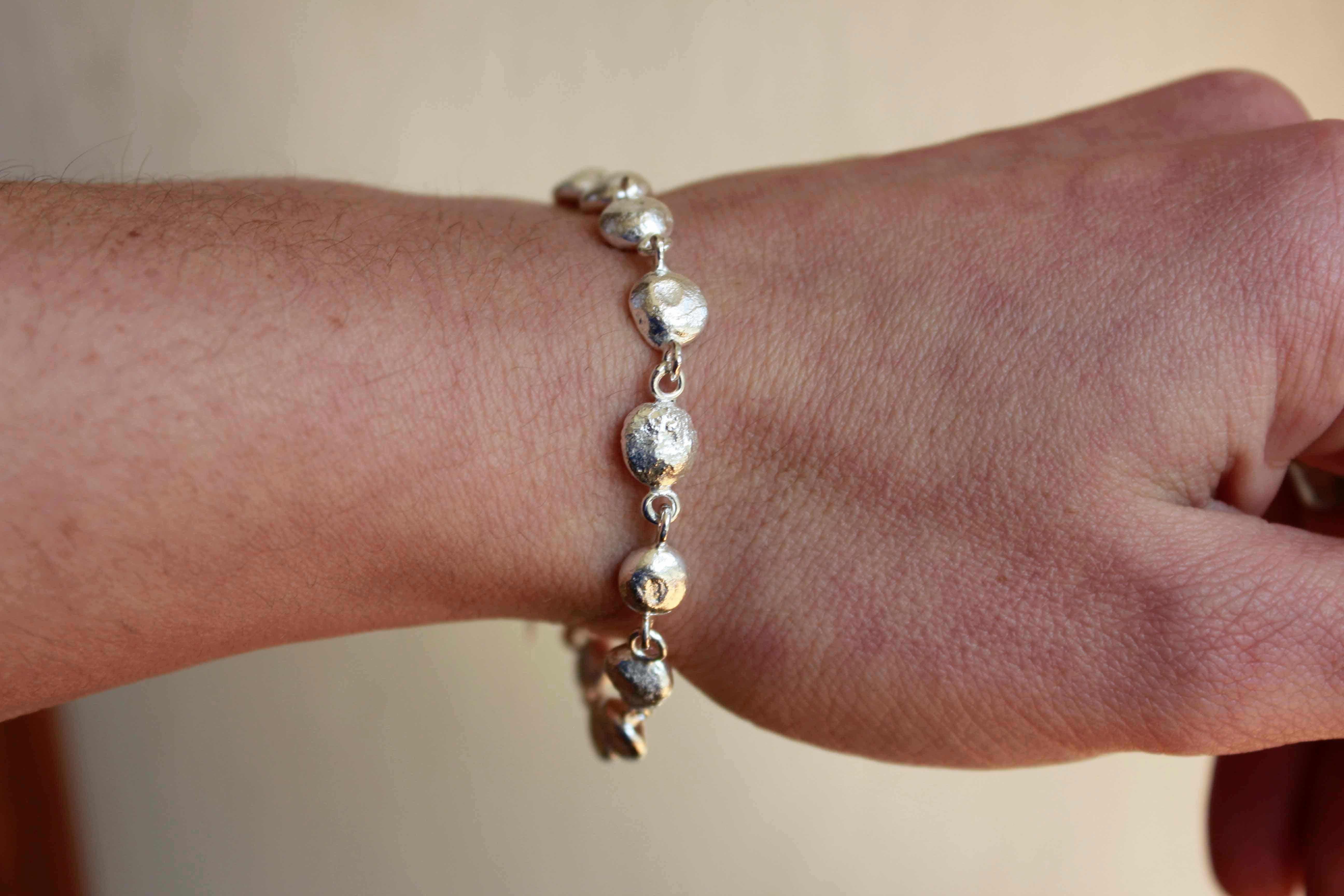 The Gaia Bracelet consists of 13 hand melted silver balls.

The small organic balls are made from our silver scrap, which means they are 100% recycled and solid.

The bracelet has 18 – 21cm length.

Each ball has approximately 0.8cm width and 0.5cm