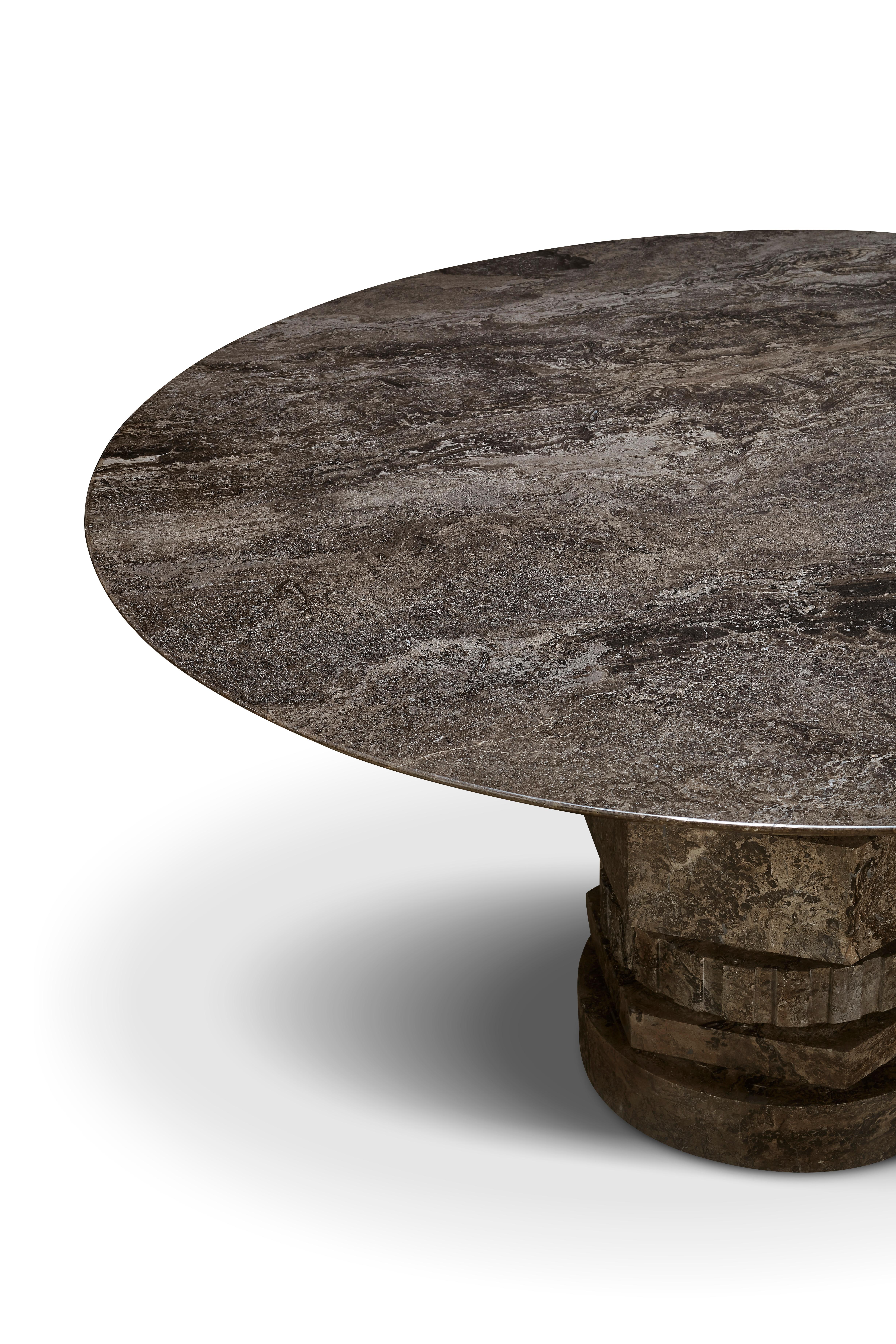 Gaia, crafted from polished Narcis marble, is a sculptural round table that serves beautifully as a dining or entry centerpiece. Its architectural silhouette draws inspiration from classical columns, while layered cylindrical forms recall mechanical