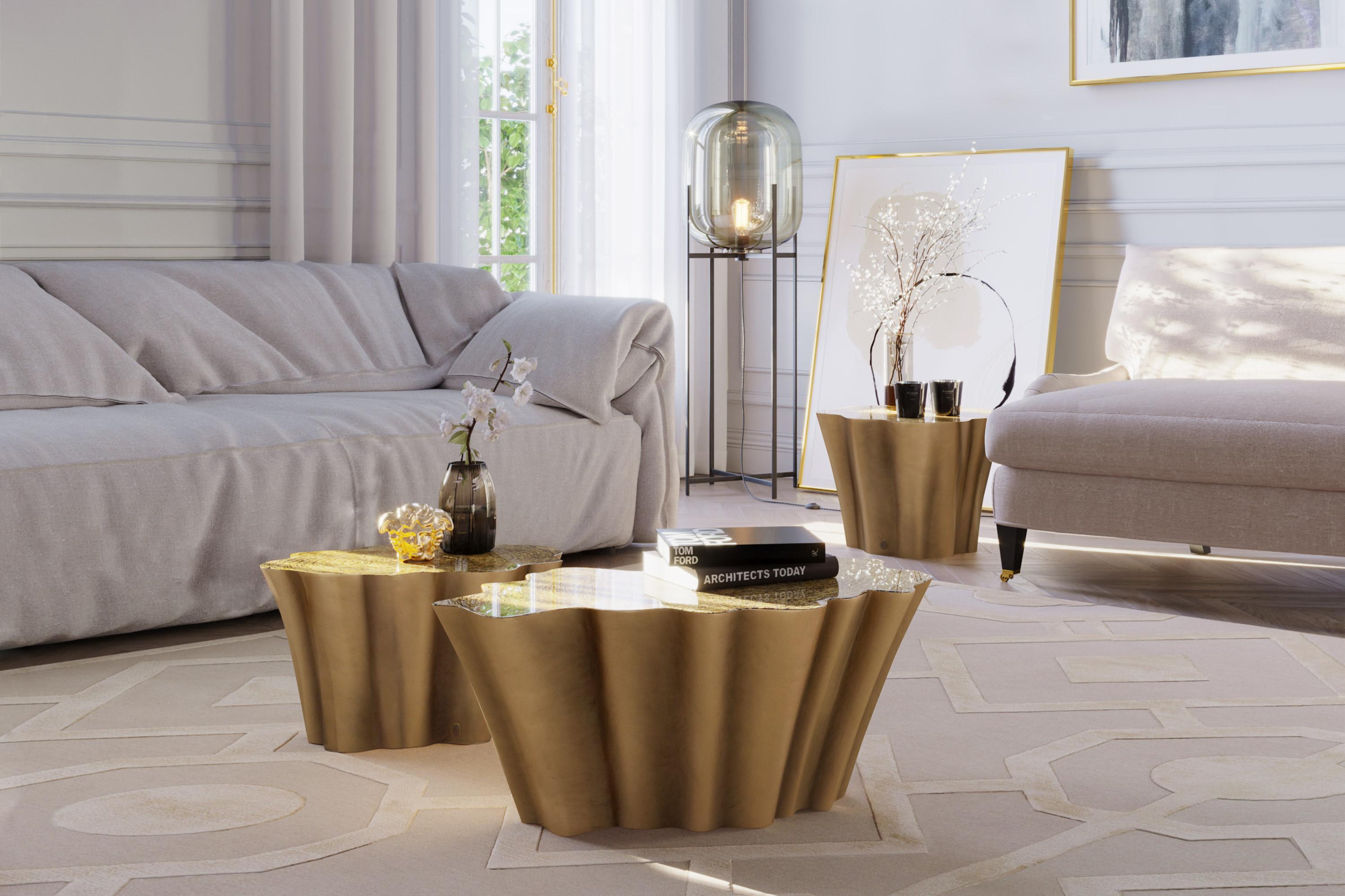 Gaia is a set of coffee tables with a tree trunk inspired shapes that combine luxurious finishes with exclusive textures.
Its table top is in textured gold leaf finish covered by clear resin and its structure is finished in aged pale gold. Its