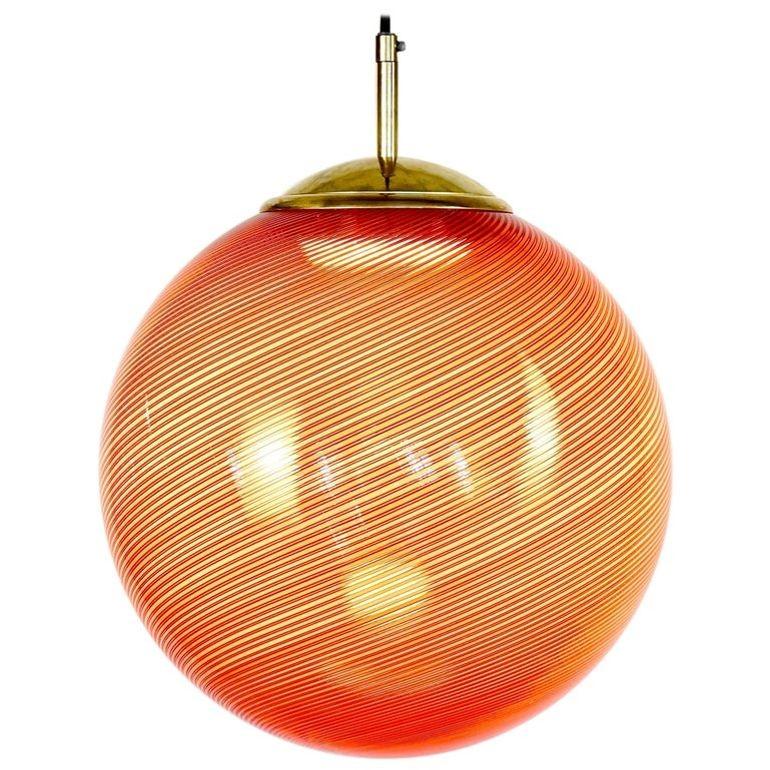 The Gaia Collection presents a series of luminous spheres, reimagining the classic Mid-century Murano Mezza Filigrana technique. These lights offer endless possibilities for creative expression, whether you envision a dynamic cluster of varied