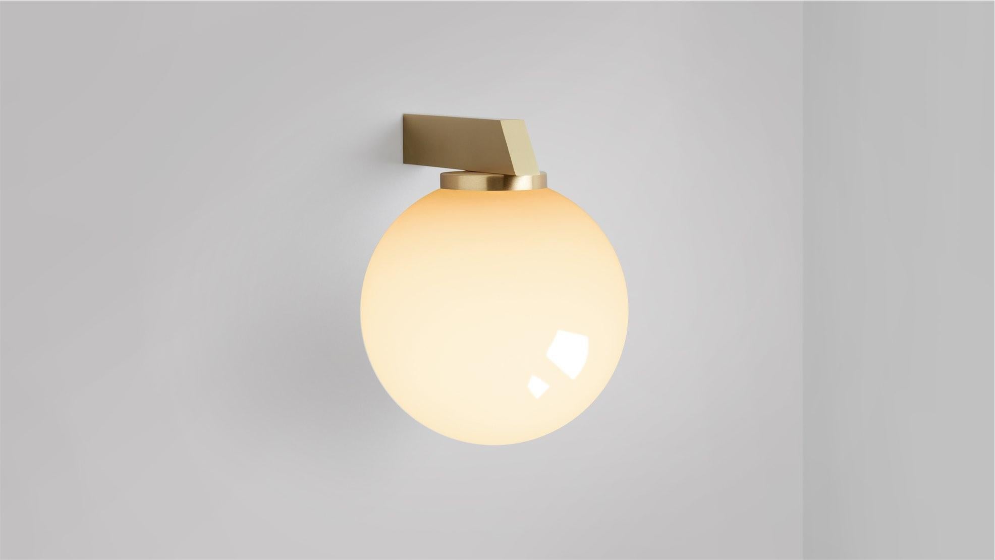 Gaia wall lamp by CTO Lighting
Materials: Satin brass with shiny opal glass.
Dimensions: D 21.4 x W 15 x H 19 cm
Available in bronze or satin brass and in hand shaped smoke glass, matte opal glass, shiny opal glass, or tinted glass. Please contact