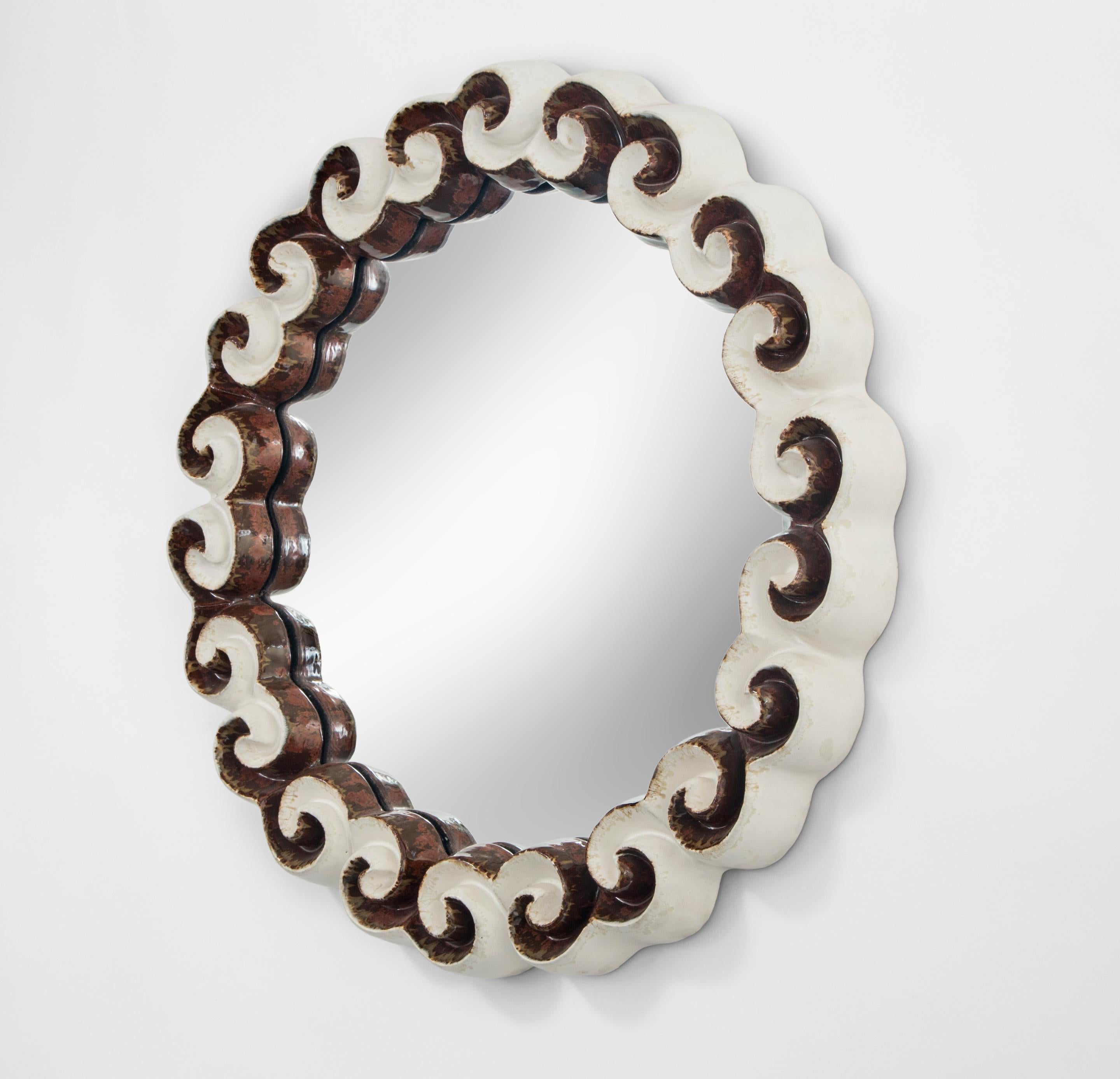 Gail Dooley, circular glazed stoneware cloud mirror
2013
The joyful classical wave scroll reinterpreted by Gail Dooley to invoke swiftly moving clouds in this deftly executed circular mirror.