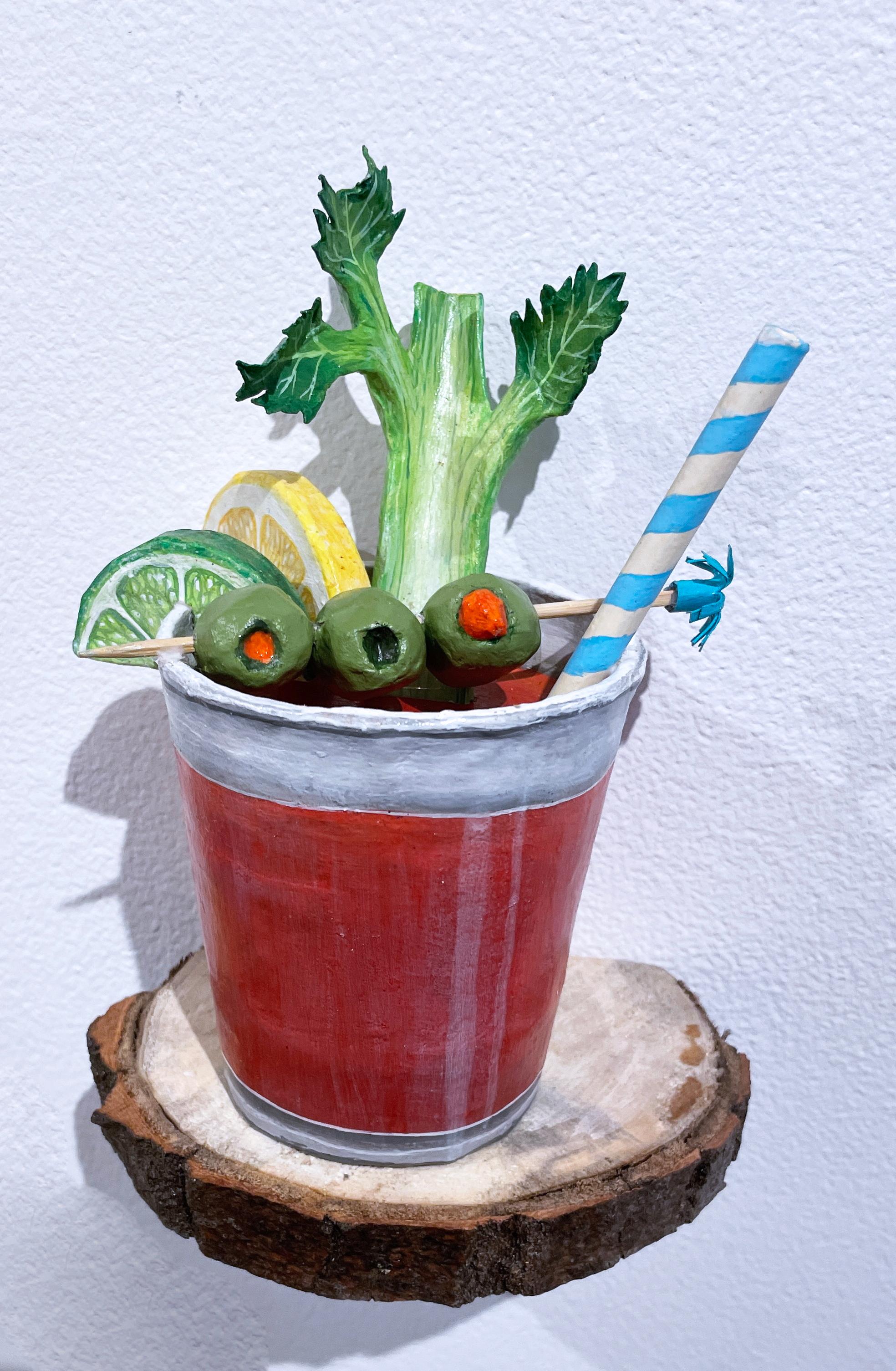 Gail M. Boykewich Figurative Sculpture - Bloody Mary, figurative paper mache wall sculpture, cocktail with celery, olive