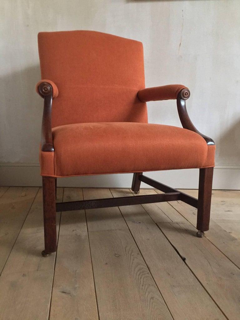 Good 19th century Gainsborough armchair in mahogany with new crimson linnen upholstery. This type of chair was named after the famous painter Thomas Gainsborough who often depicted these in his works. To the contemporary it was actually known as a