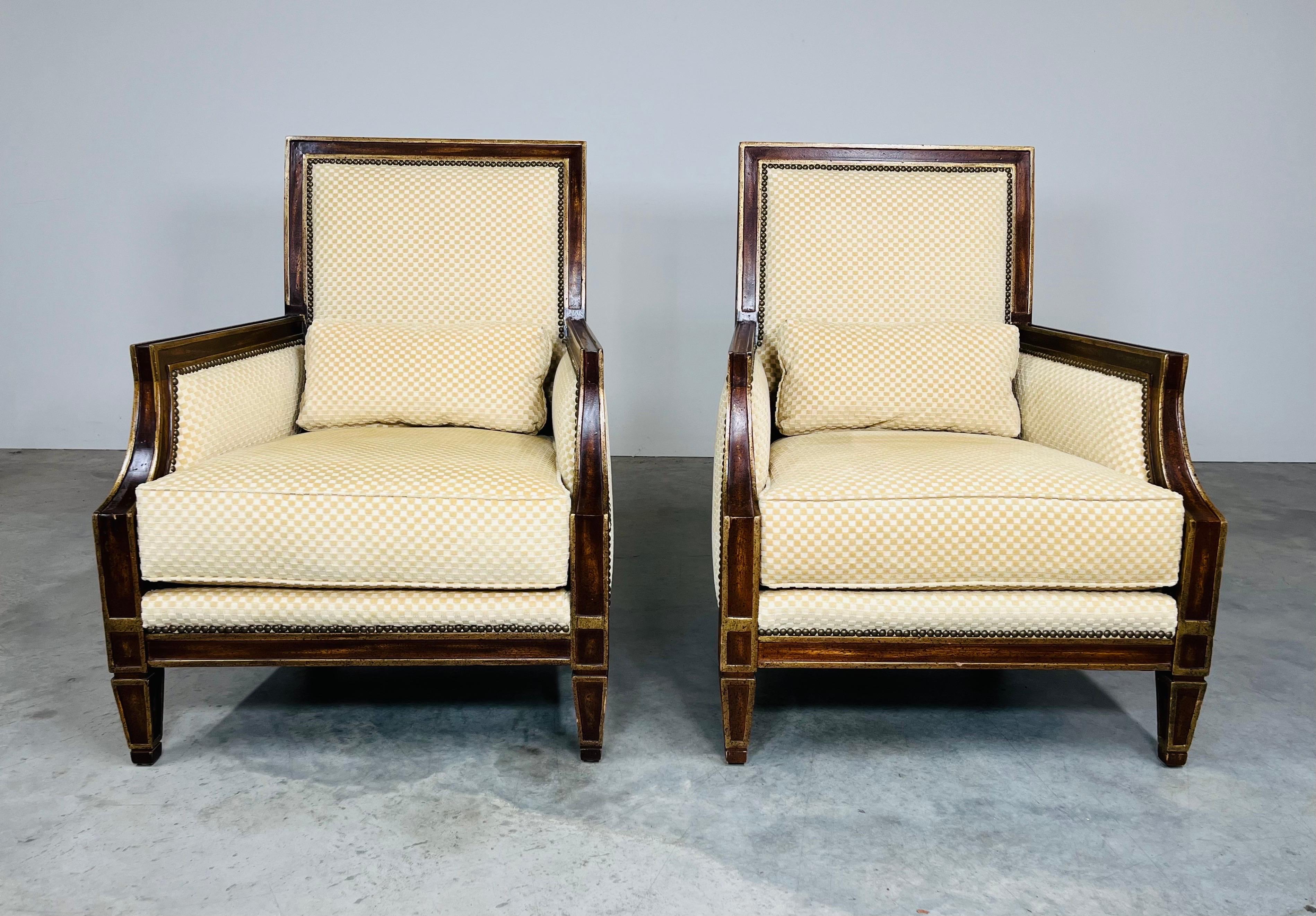 An elegant and incredibly comfortable pair of Georgian Gainsborough style lounge chairs by Matteo Fine Furnishings of High Point, N.C. having stained mahogany and gold gilt frames upholstered in a cotton/poly blend patterned velvet lined with brass