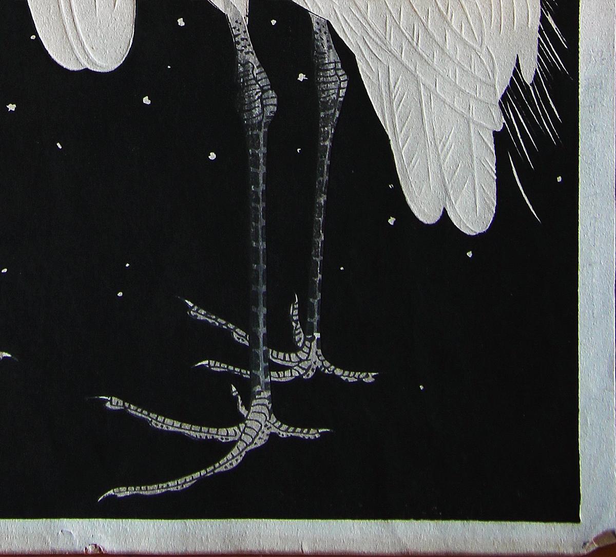 Japanese woodblock print of two white herons by Japanese artist Gakusui Ide and published by Shozaburo Watanabe. The piece features two white herons set against a stark black background speckled with fresh flakes of falling snow. The work is a