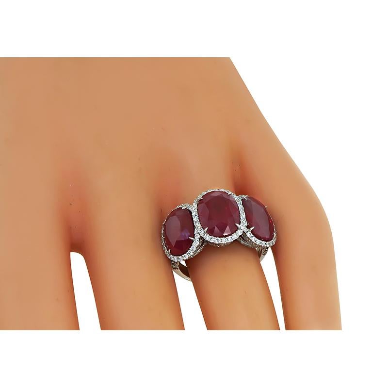 This is a fabulous 18k white gold ring. The ring features 3 lovely GAL certified oval cut rubies that weigh approximately 12.18ct. The rubies are accentuated by sparkling round cut diamonds that weigh approximately 1.00ct. The color of these