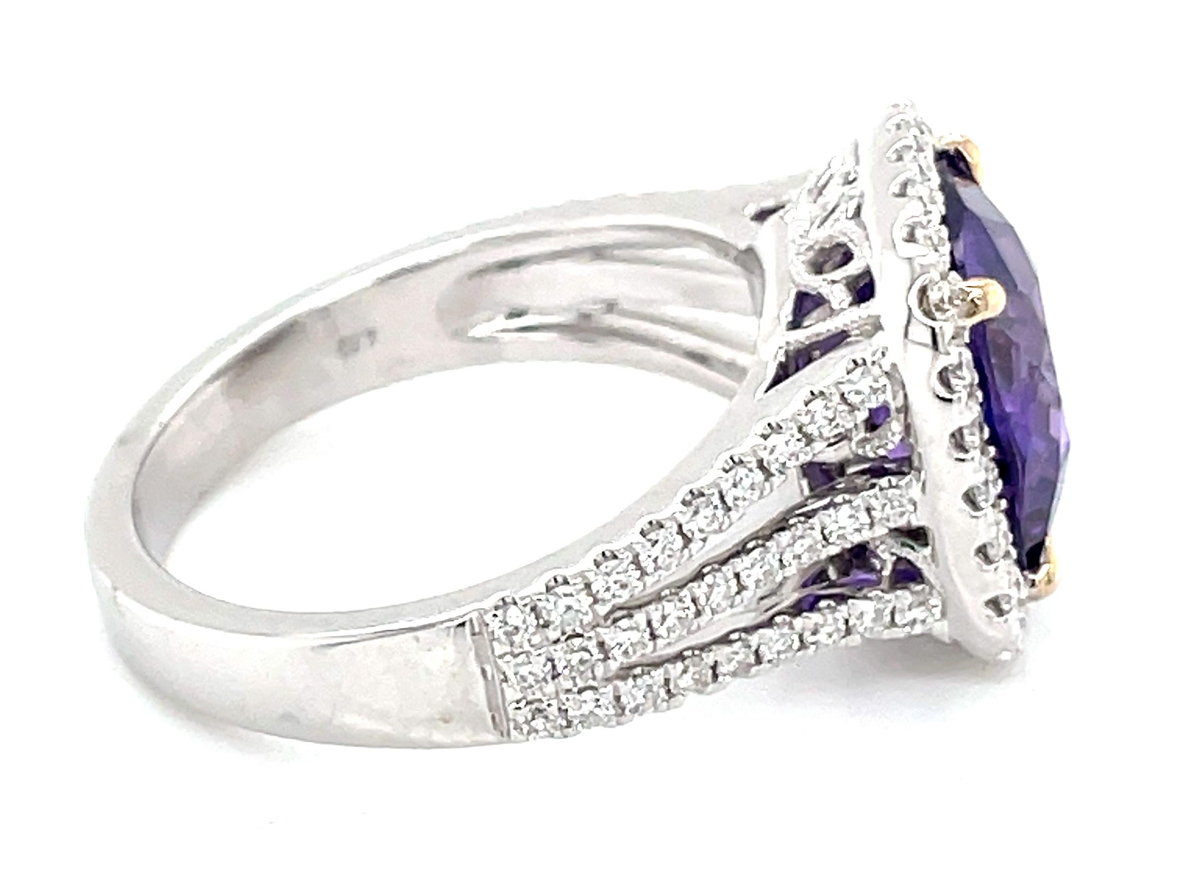 This stunning cocktail ring showcases a beautiful GAL Certified Natural No Heat 4.59 Carat Cushion Purple Sapphire with a Diamond Halo. This stunning sapphire sits on a triple diamond shank and the ring is set in 18k white gold with yellow gold