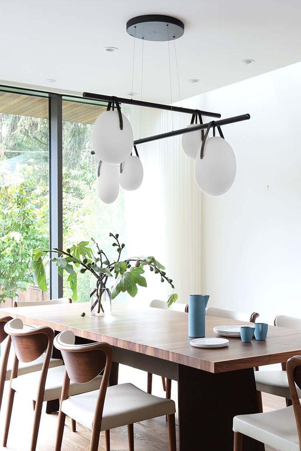 Gala Cross / Chandelier
Designed by RBW

Gala is a minimal, near-weightless take on the chandelier, rethought as a simple beam with power cords hidden inside the slim suspension cables. Its ivory-frosted glass fixtures, fixed in a variety of
