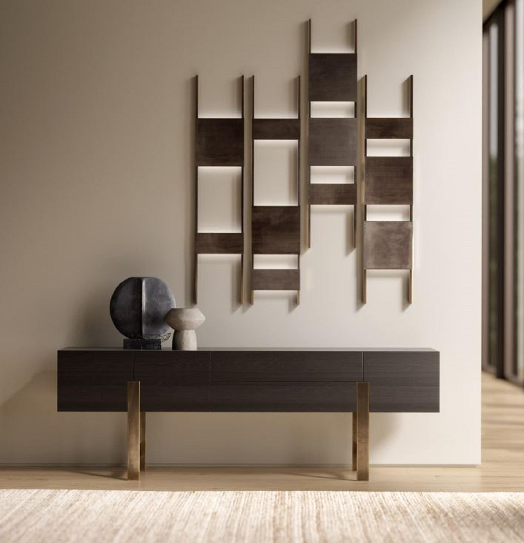 The Gala sideboard, designed by Ferruccio Laviani for Emmemobili, stands out for its refined simplicity and perfect proportions. A solid body appears to float on a finely crafted metal base made of brass or steel. This elegant frame enhances the