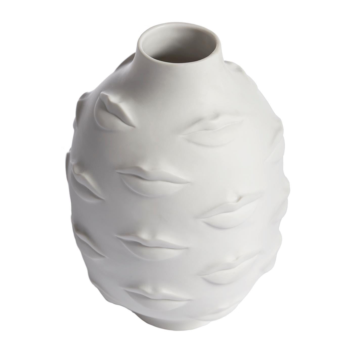Conversation piece. An expressive collection of moody mouths wrap a vessel crafted from high-fired unglazed porcelain exterior with a glazed interior. A kiss of cool for your table, mantel, or shelf. Inspired by Gala, wife and muse of Salvador