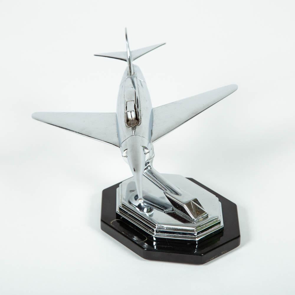 A 1950s chrome jet airplane desk lighter by Gala Sonic of England. 

The aircraft moves on a ball joint to angle the lighter.
 