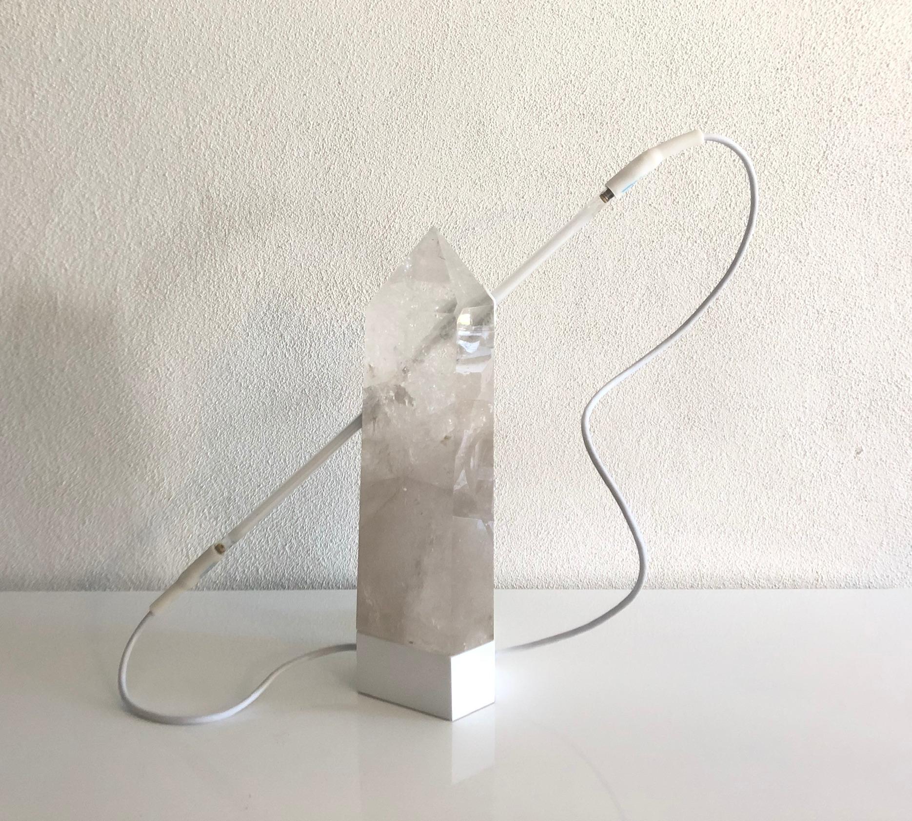 ‘GALACTIC RECEPTOR’ is a sculptural table lamp using quartz crystal as the body then pierced with a millennial pink neon tube. When powered off the piece is entirely white. When ignited the neon creates a spectacle of other worldly glowing light