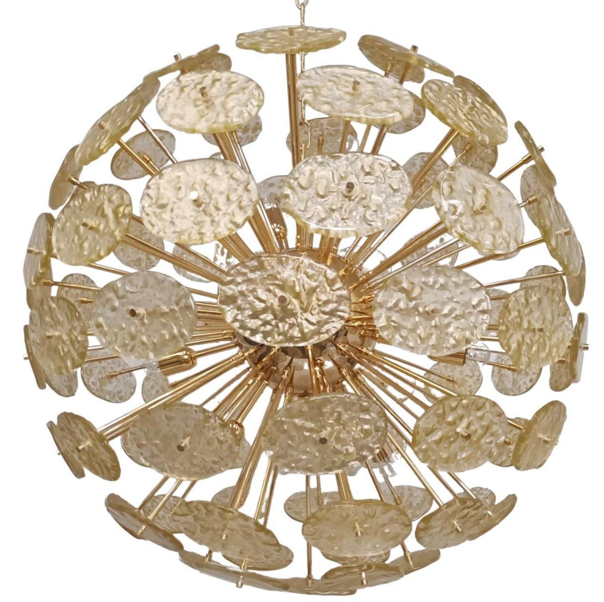 
Italian Sputnik chandelier with oval shaped textured Murano glass discs in light gold color, mounted on 24 karat gold plated metal frame / Made in Italy, 1970's.
Measures: Diameter 37.5 inches, Height 61 inches including chain and canopy
