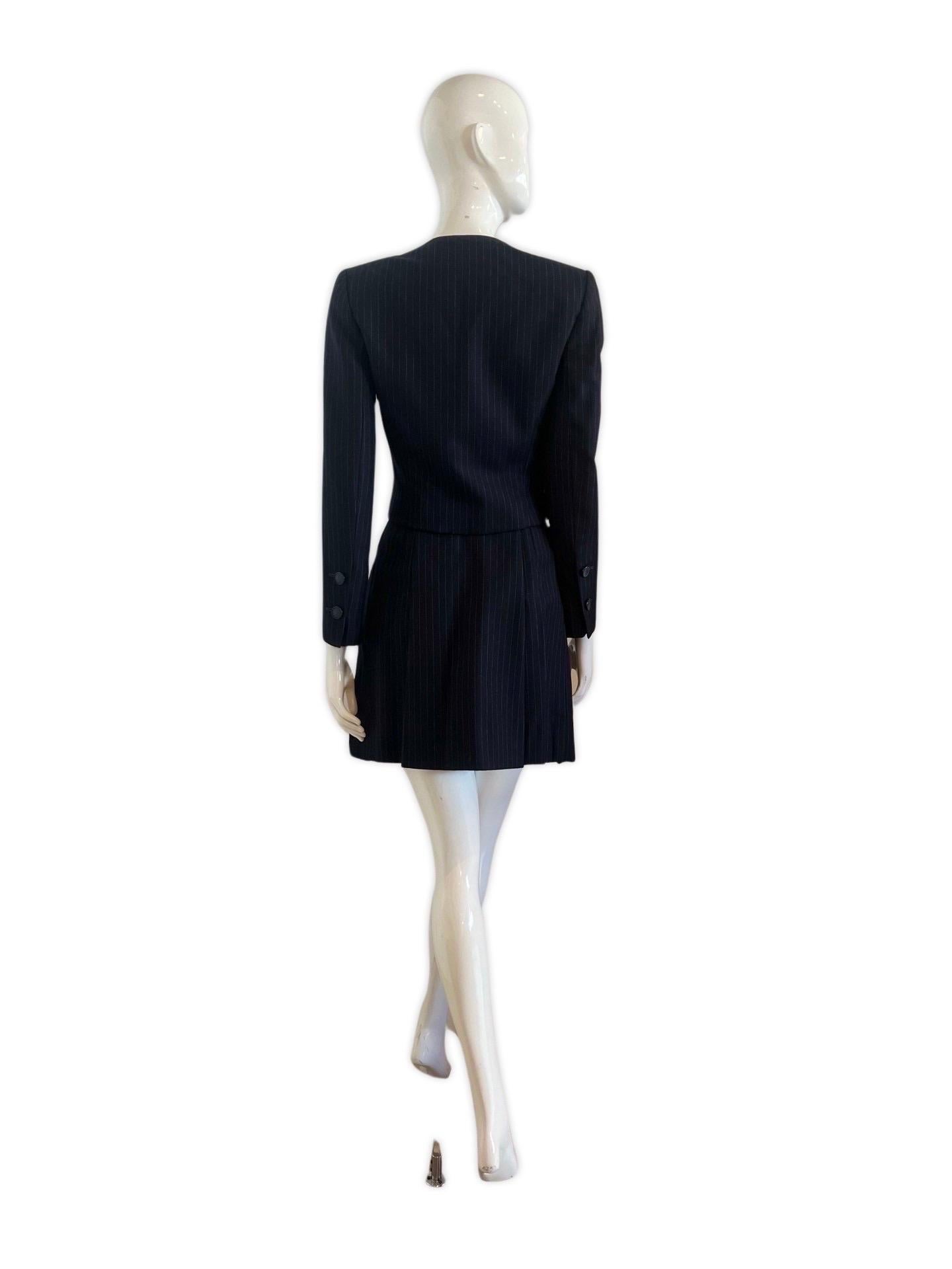 An incredible, mint condition Galanos pinstripe wool skirt suit with a pleated school girl mini and short structured jacket. James Galanos (1924–2016) was an American fashion designer known for his exquisite craftsmanship and elegant designs. He