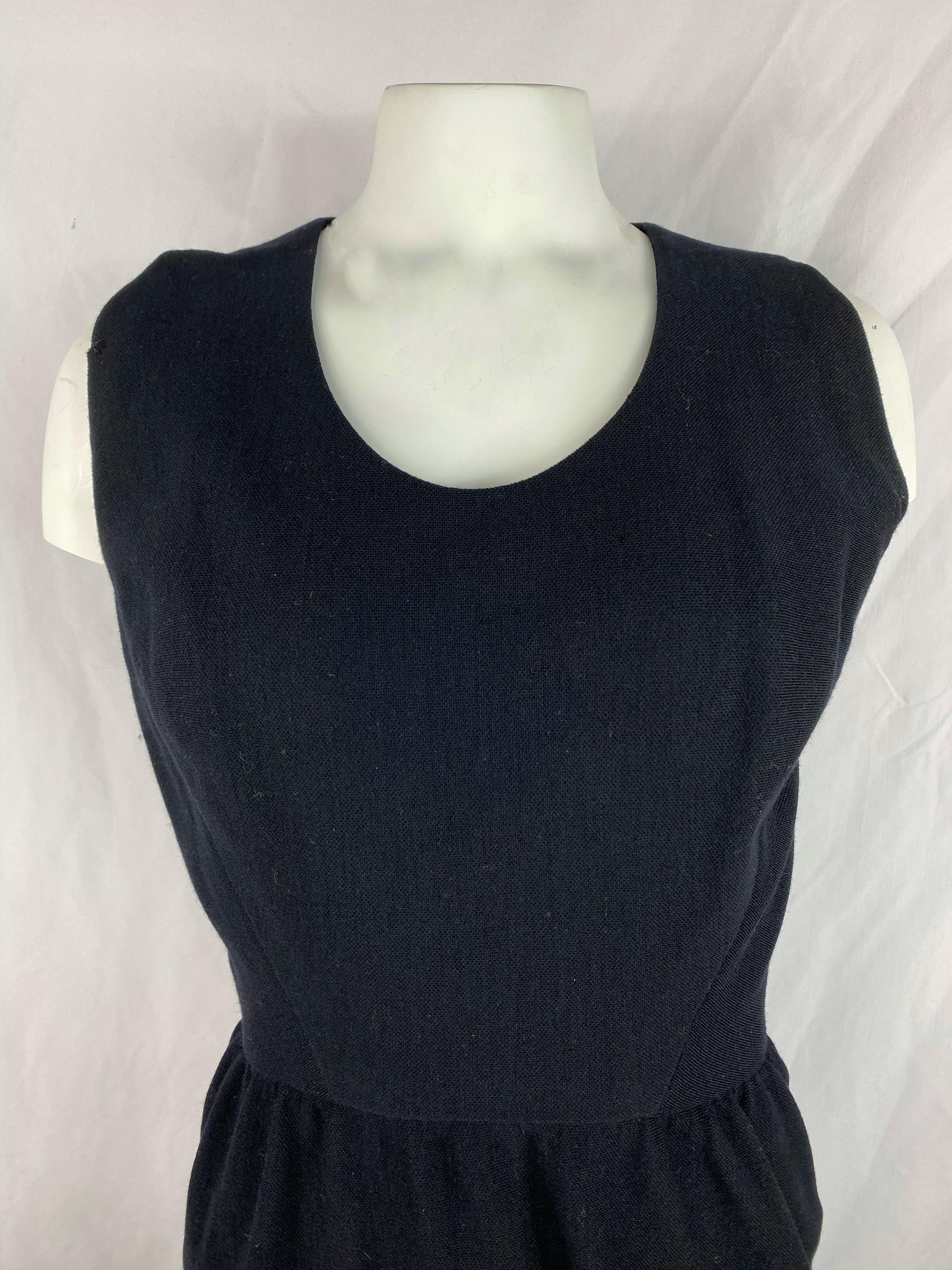 Product details:

The dress features crew neck line, mini length, kind of wrap around design with side zipper closure and waist hooks for the back wrap. Material tags are missing, feel like wool blend.