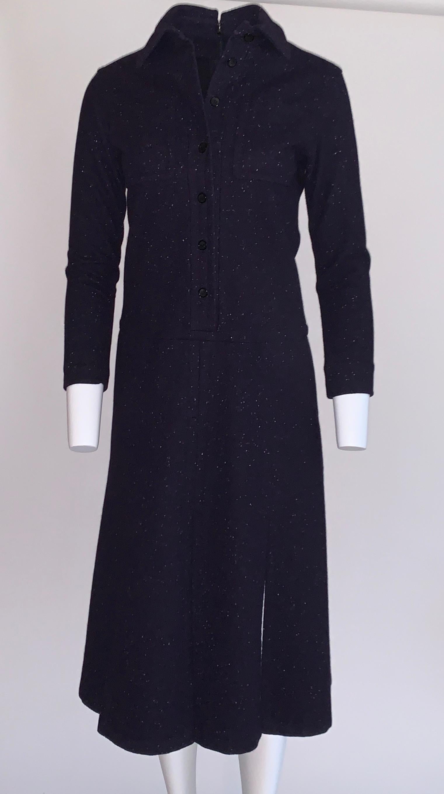 Vintage 1960s James Galanos for Amelia grey wool shirt dress in a navy blue mid-to-heavy weight wool with white speckles throughout. Button front at bodice with collar and patch pockets at chest. Pockets at side seams. Skirt has multiple slits, so